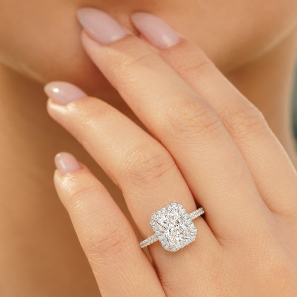3.5 carat radiant cut engagement ring on model with nude nails