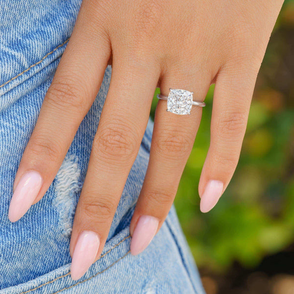woman wearing silver cushion cut engagement ring