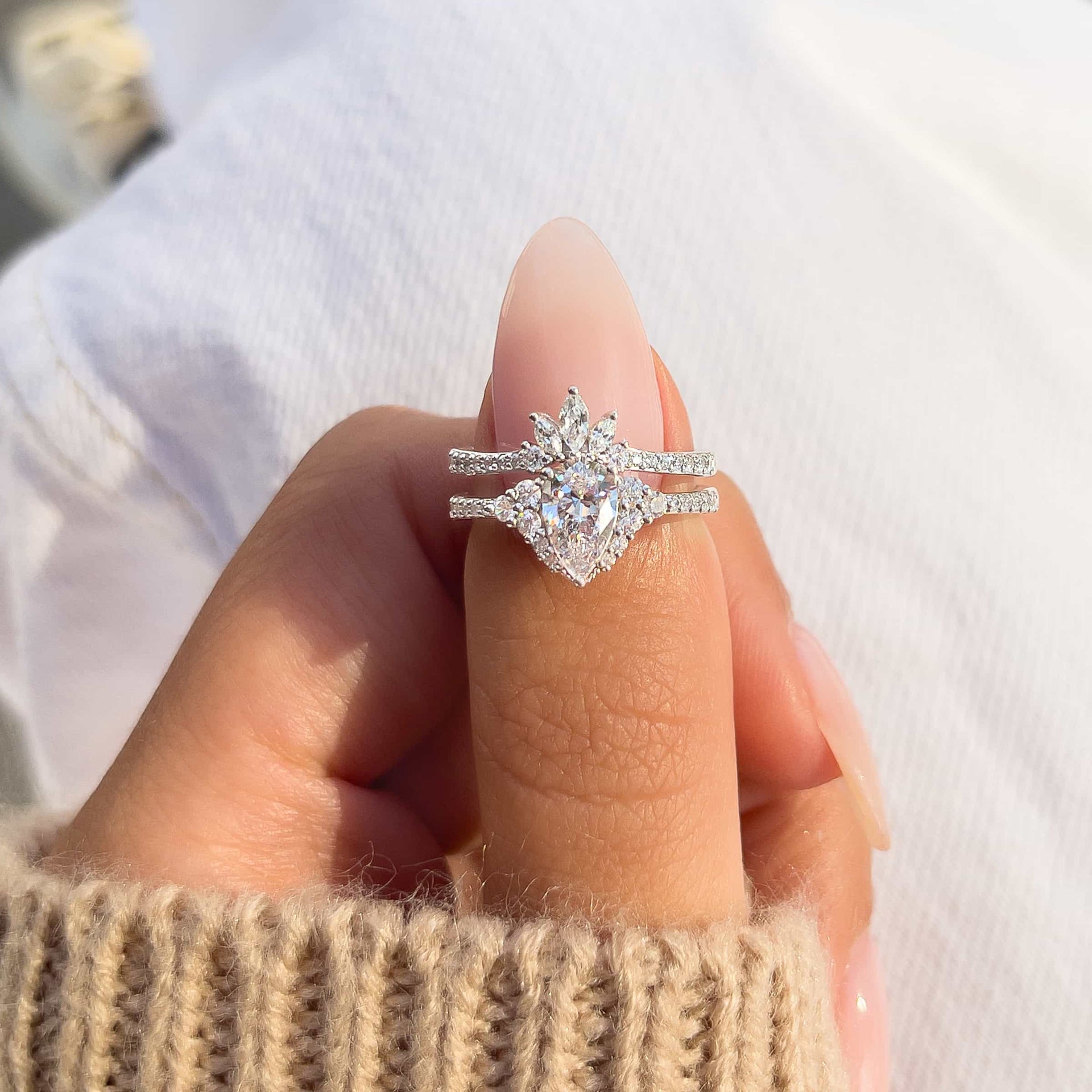 Woman pinching beautiful vintage wedding ring set
