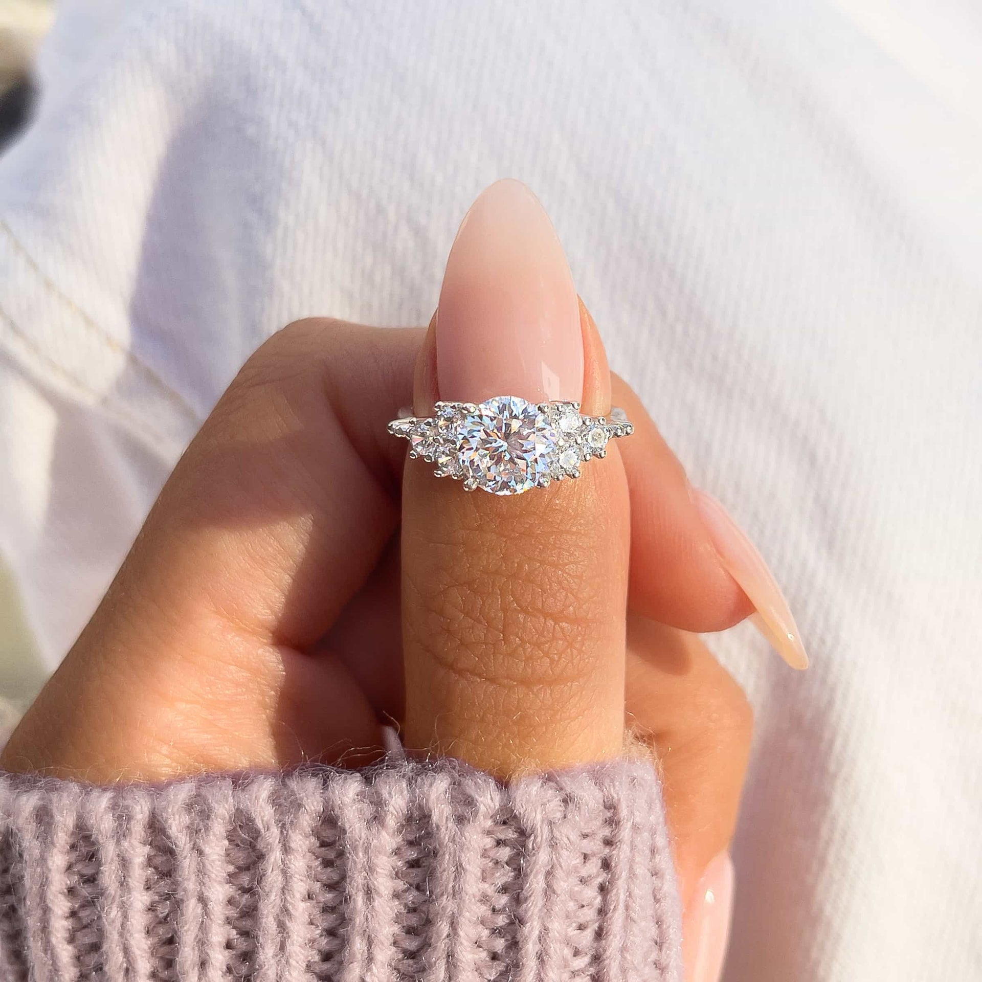 Beautiful silver engagement ring on woman's finger