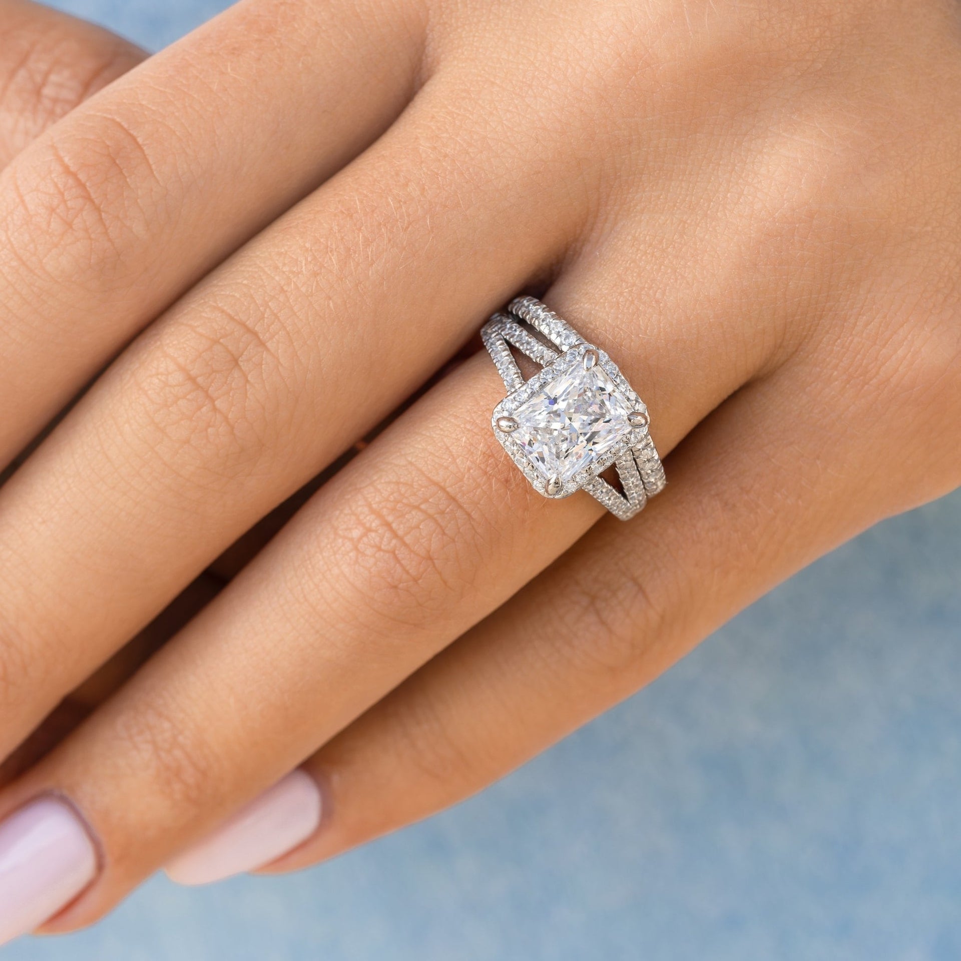 classic radiant cut engagement ring and matching half eternity band modeled on female hand