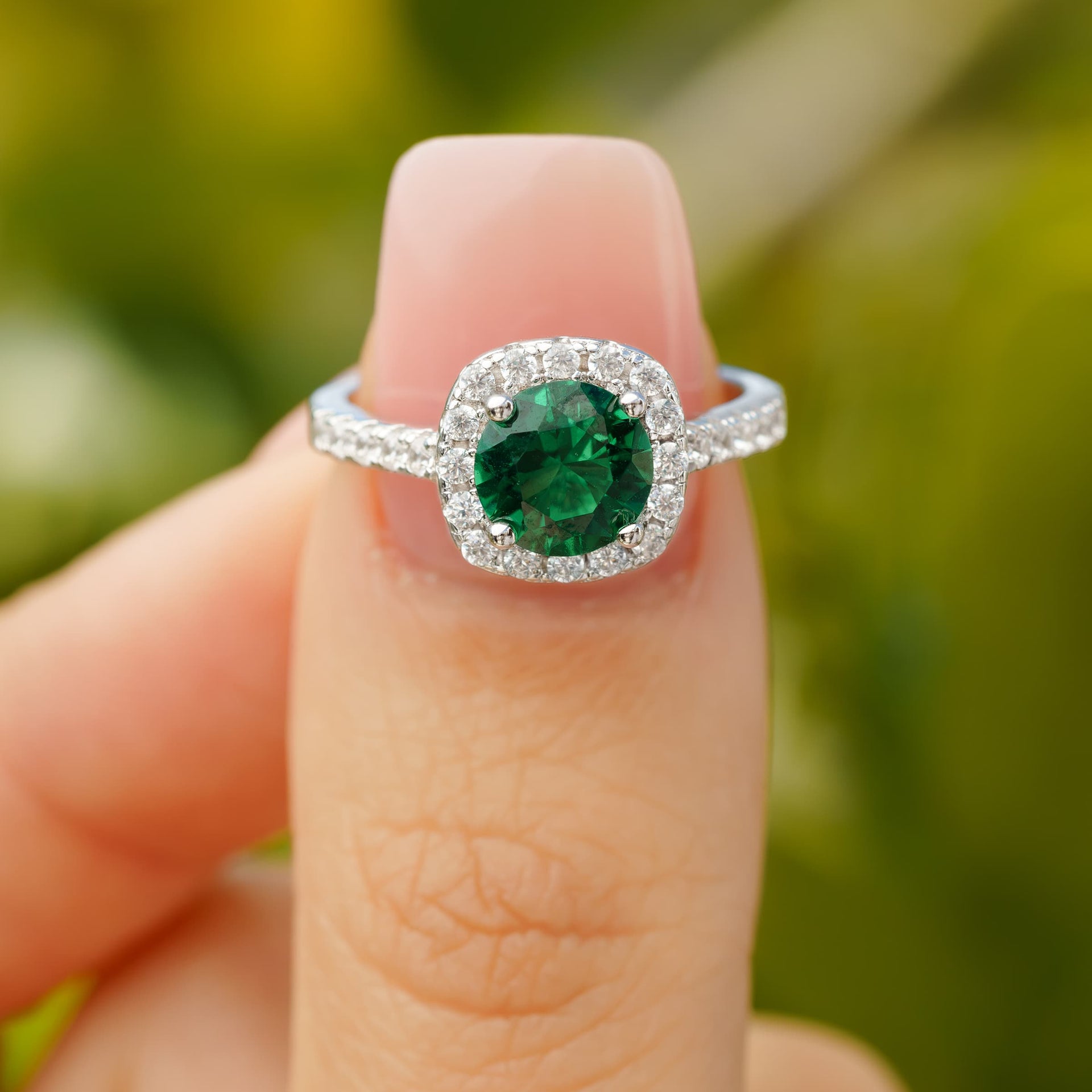 beautiful halo emerald affordable engagement ring pinching on finger