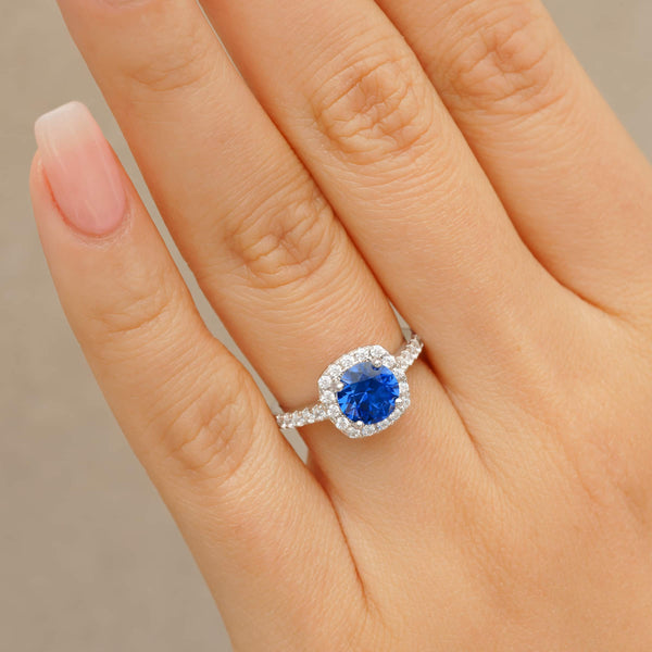 woman wearing halo tanzanite engagement ring on ladies hand