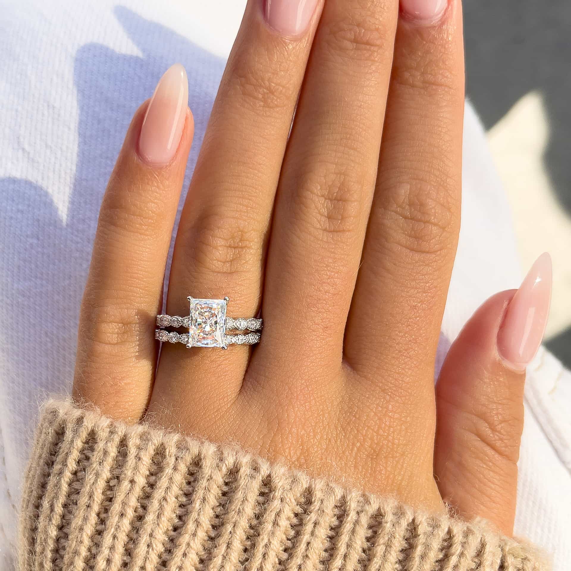 woman wearing beautiful silver vintage engagement ring with brown sweater
