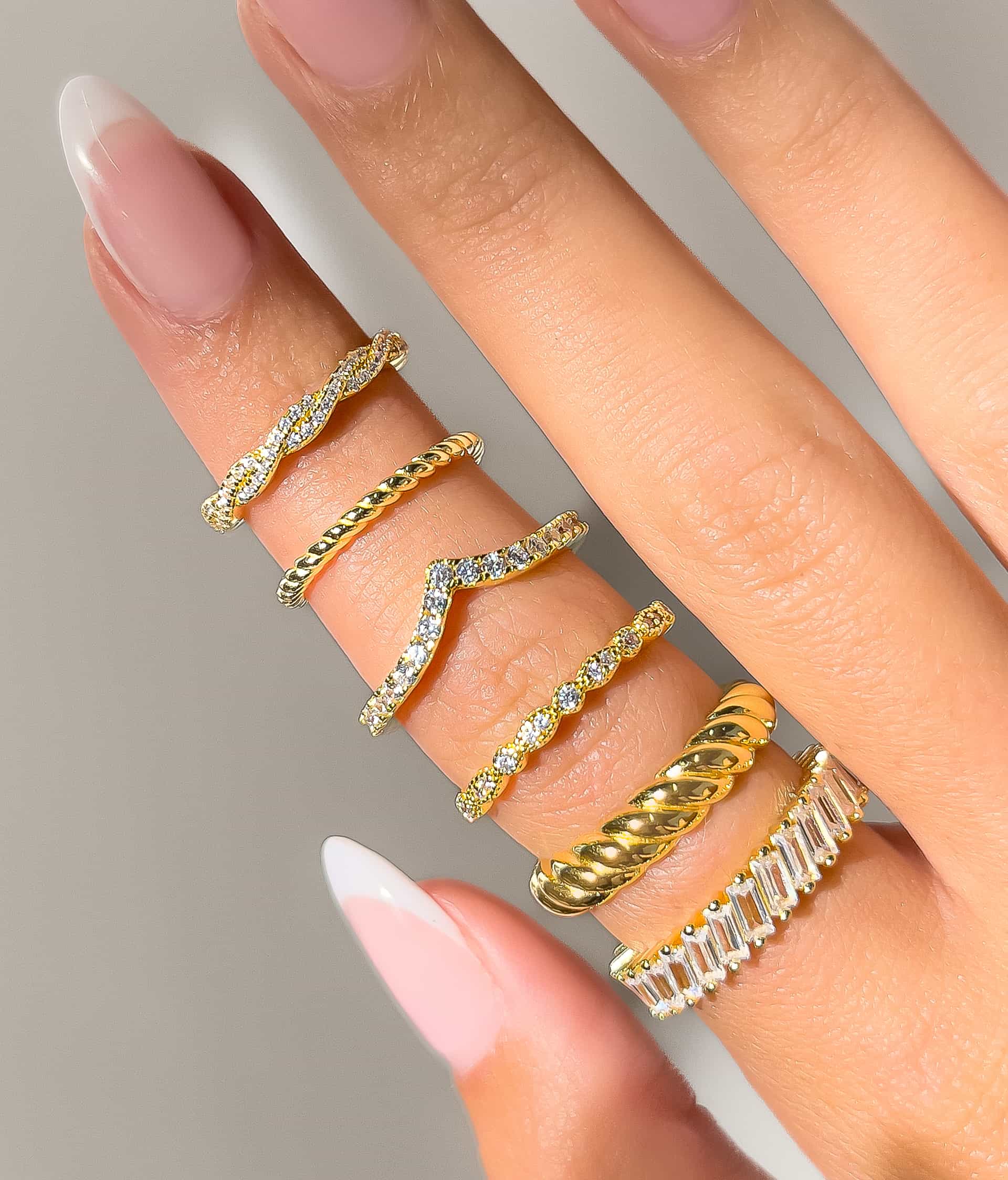woman wearing gold wedding ring stacks