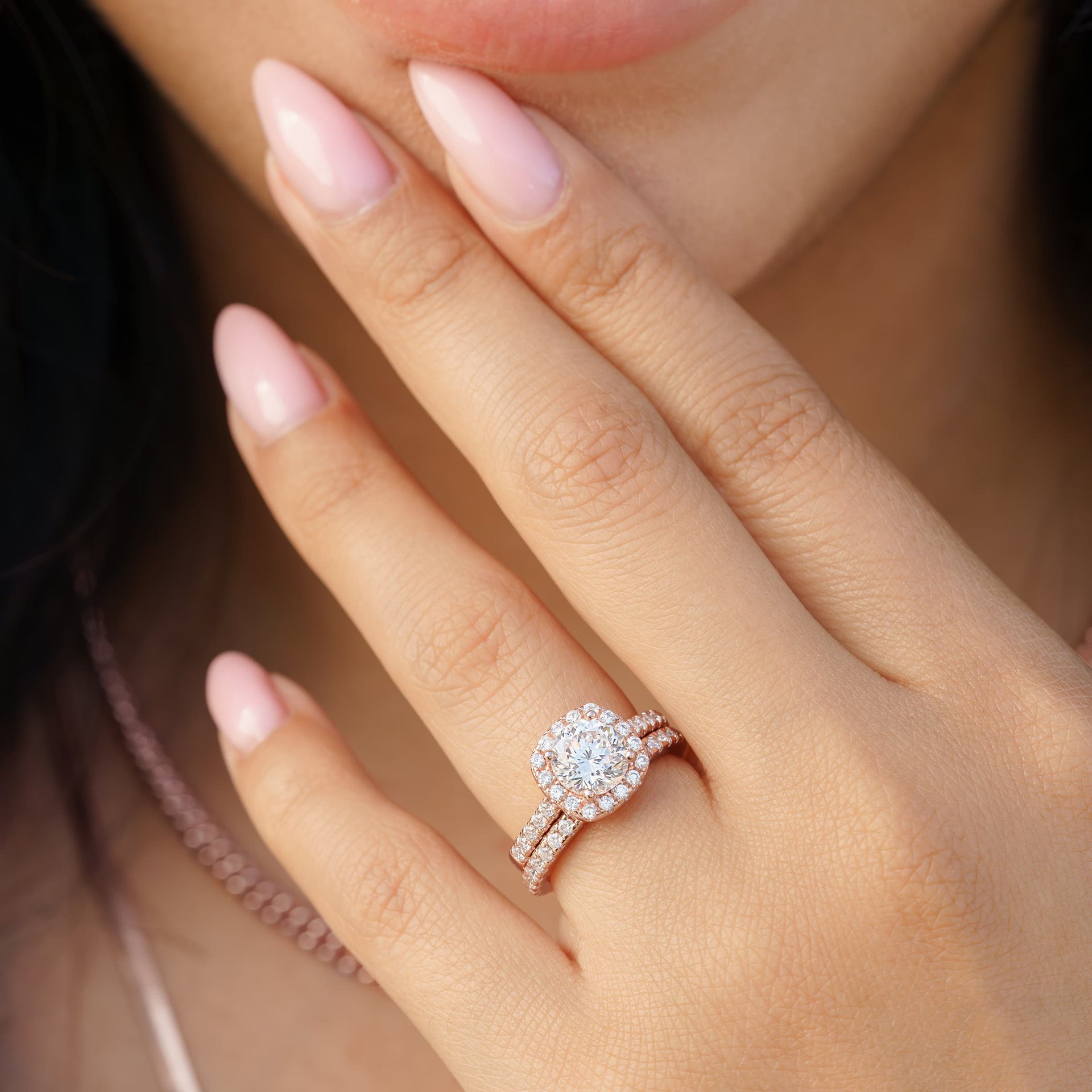 woman wearing rose gold cushion cut engagement ring 