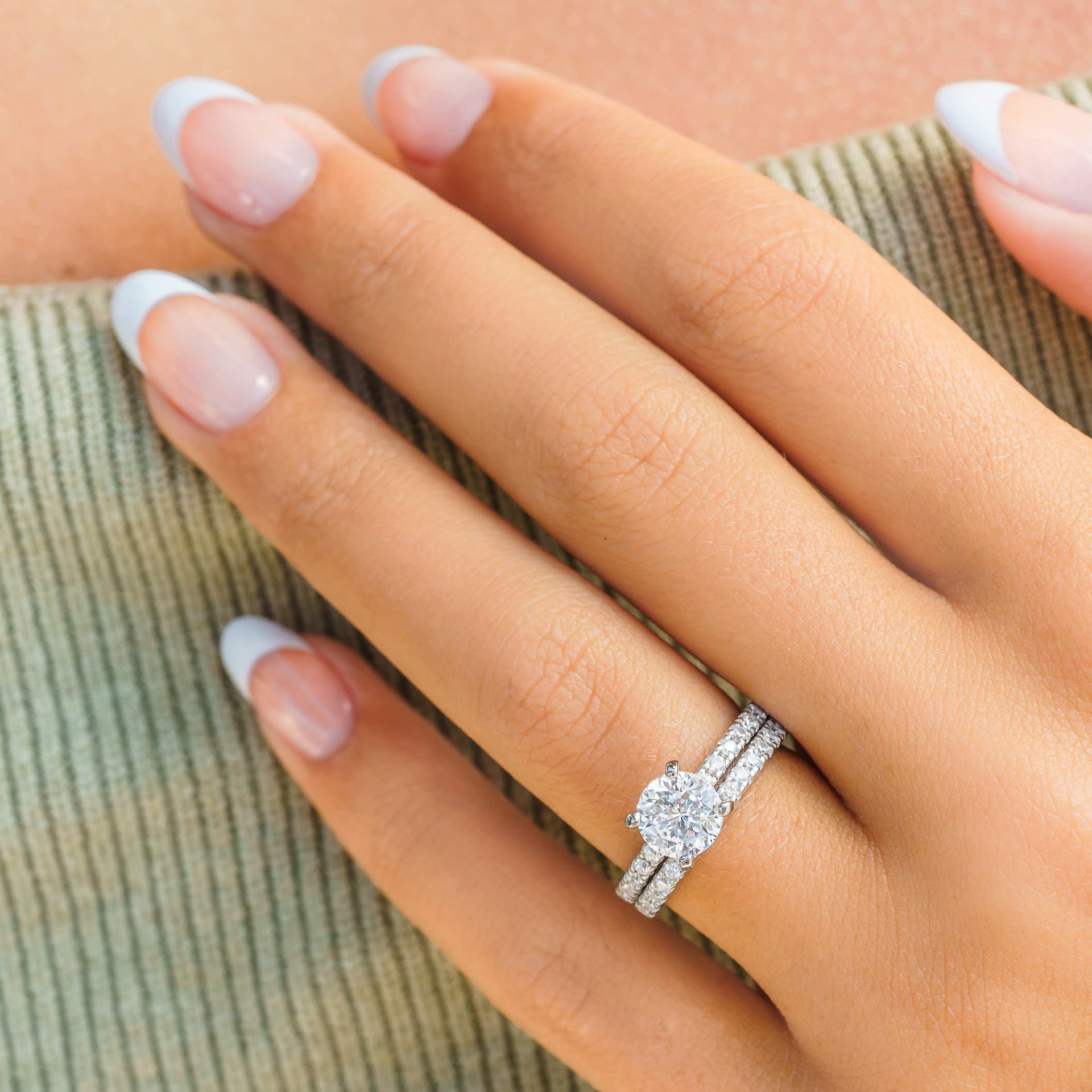 woman wearing round cut wedding ring set in silver