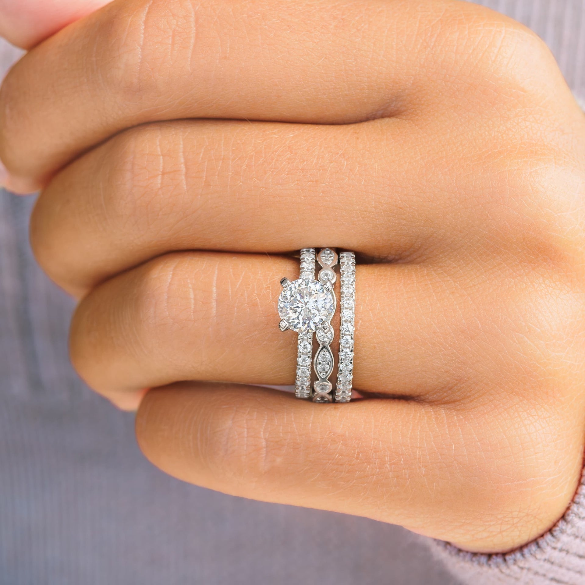woman wearing silver star light wedding ring set triple stack