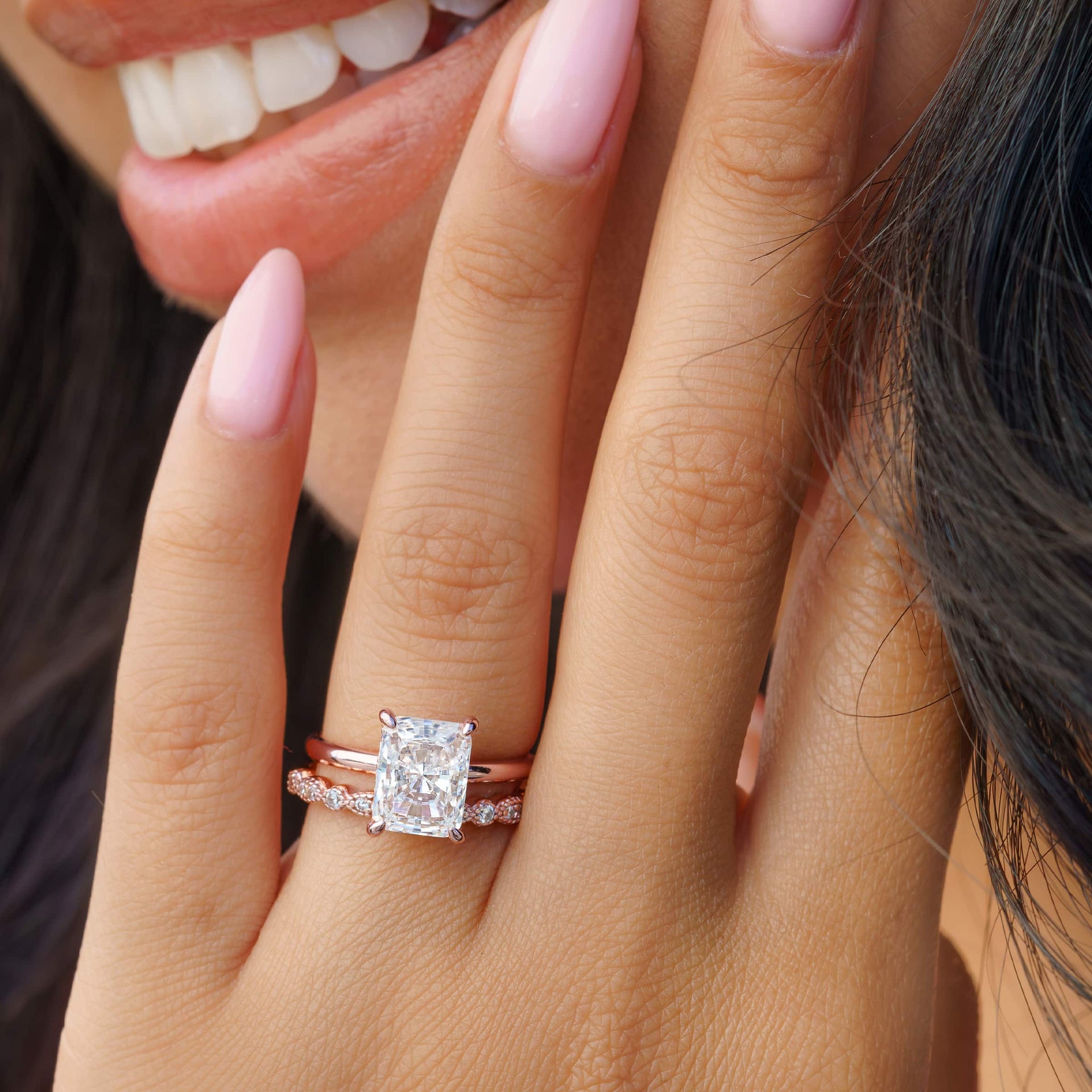 woman wearing rose gold radiant cut engagement ring with vintage wedding band