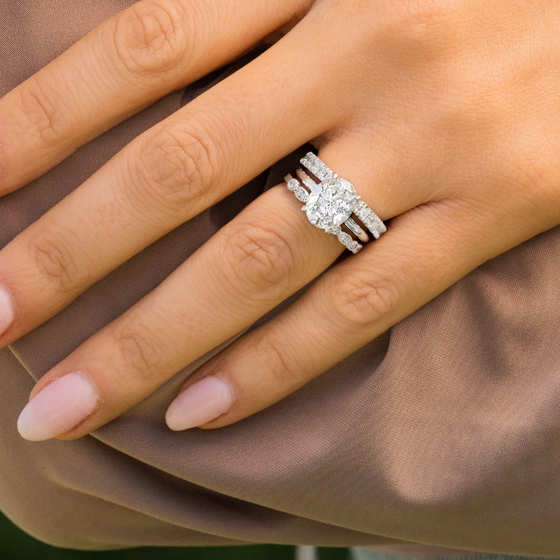 woman wearing triple stack engagement ring with forever band