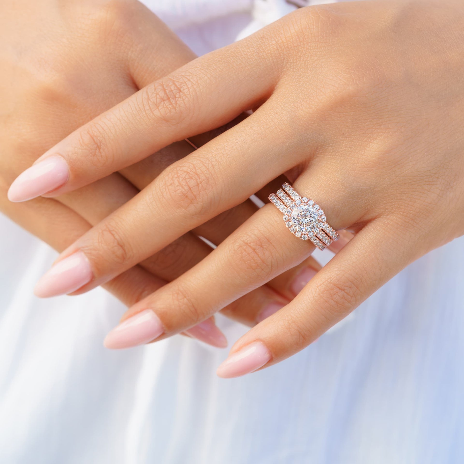 woman wearing triple stack rose gold cushion cut engagement ring