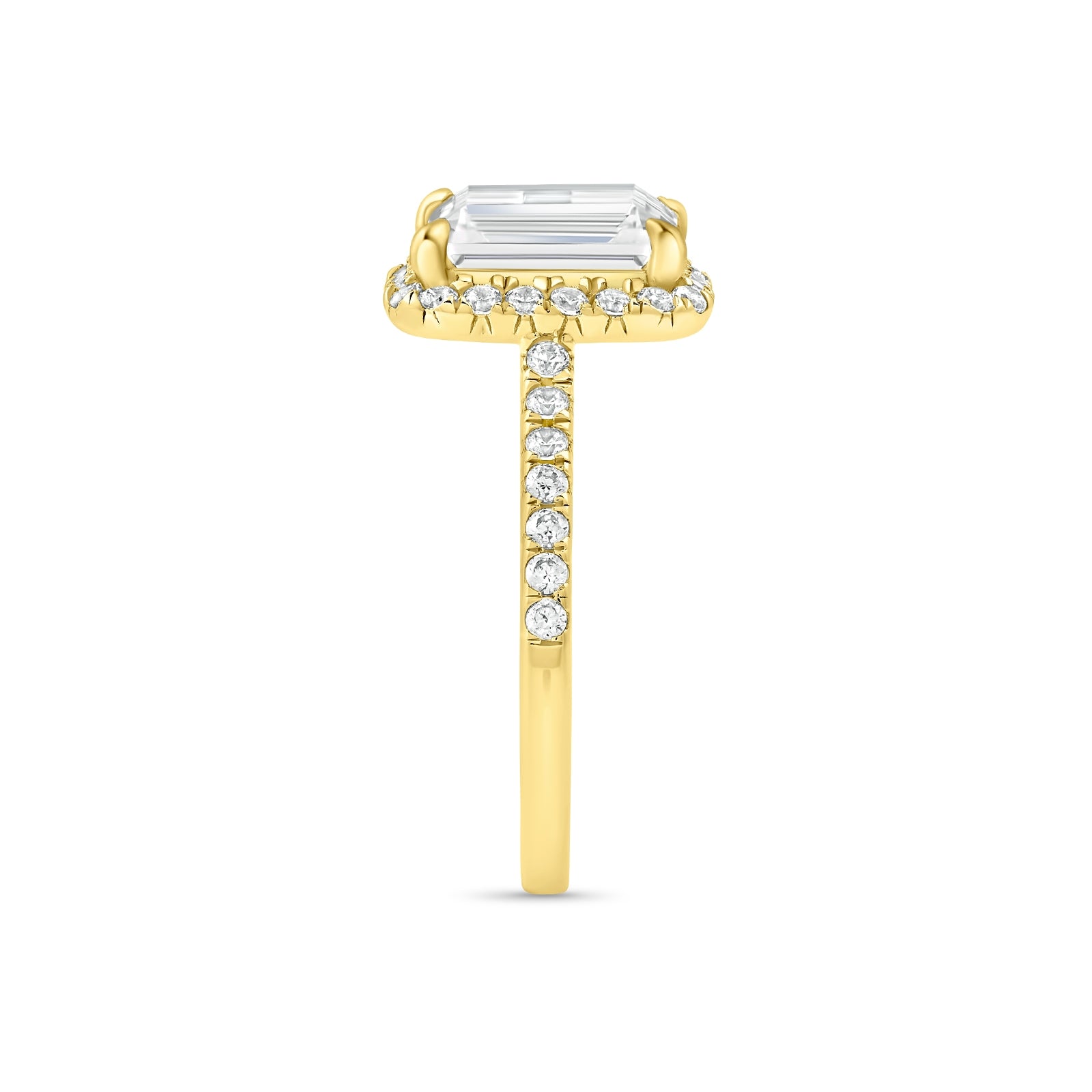 Side profile of gold emerald cut engagement ring with half eternity band detailing 