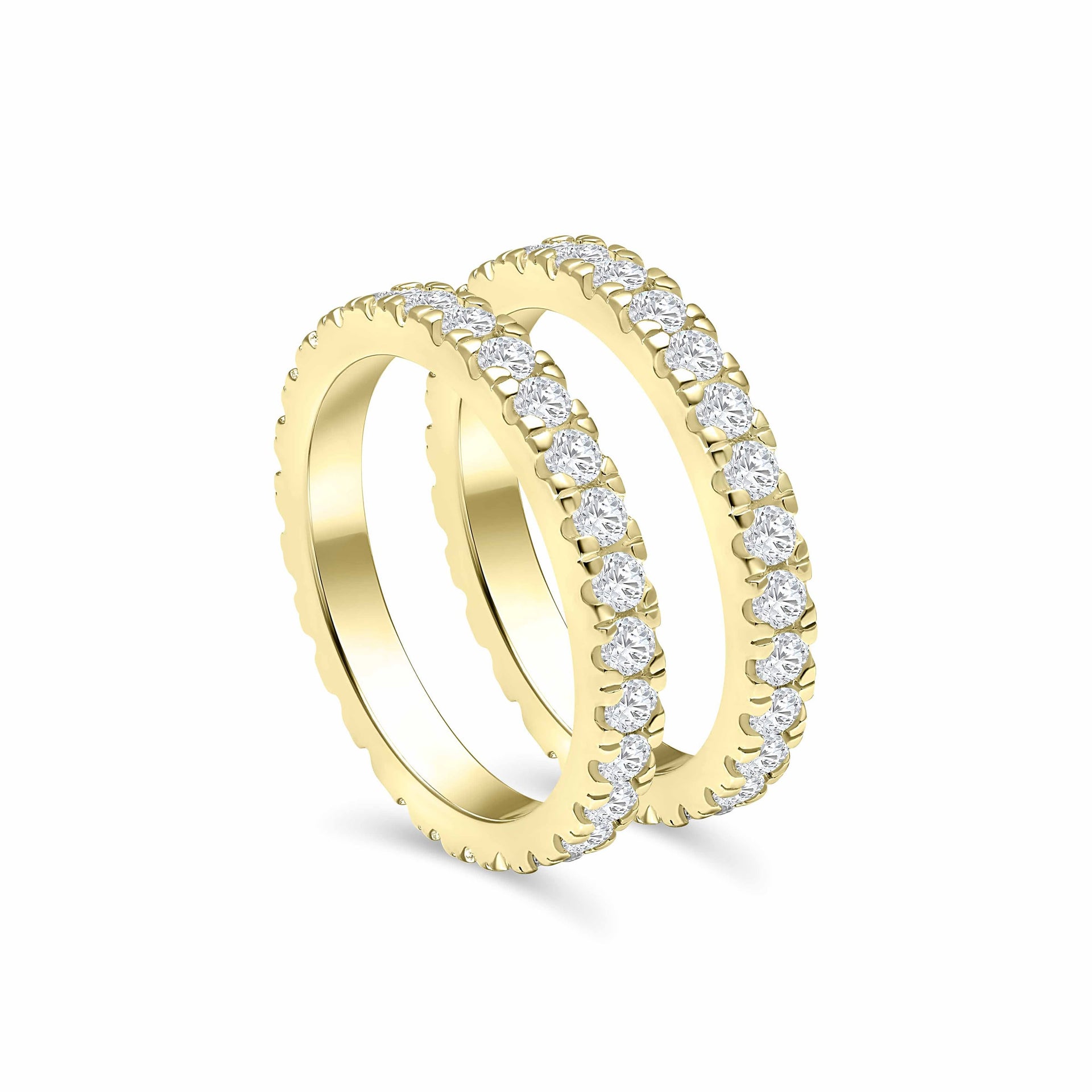 two gold full eternity statement wedding bands at a slightly tilted angle