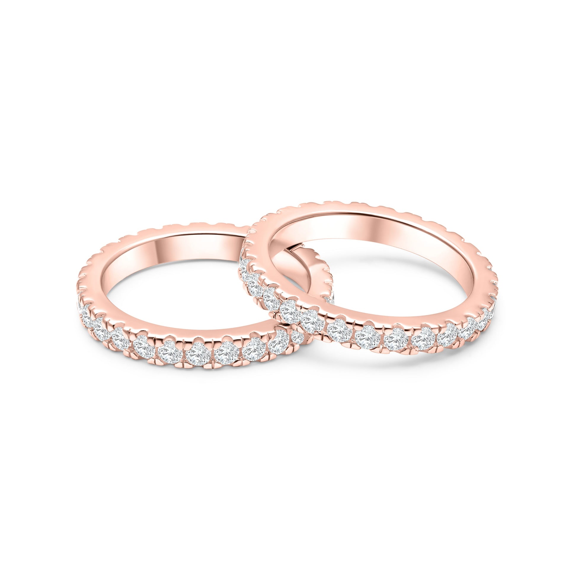 top view of rose gold eternity wedding band set, with one band leaning slightly on the other