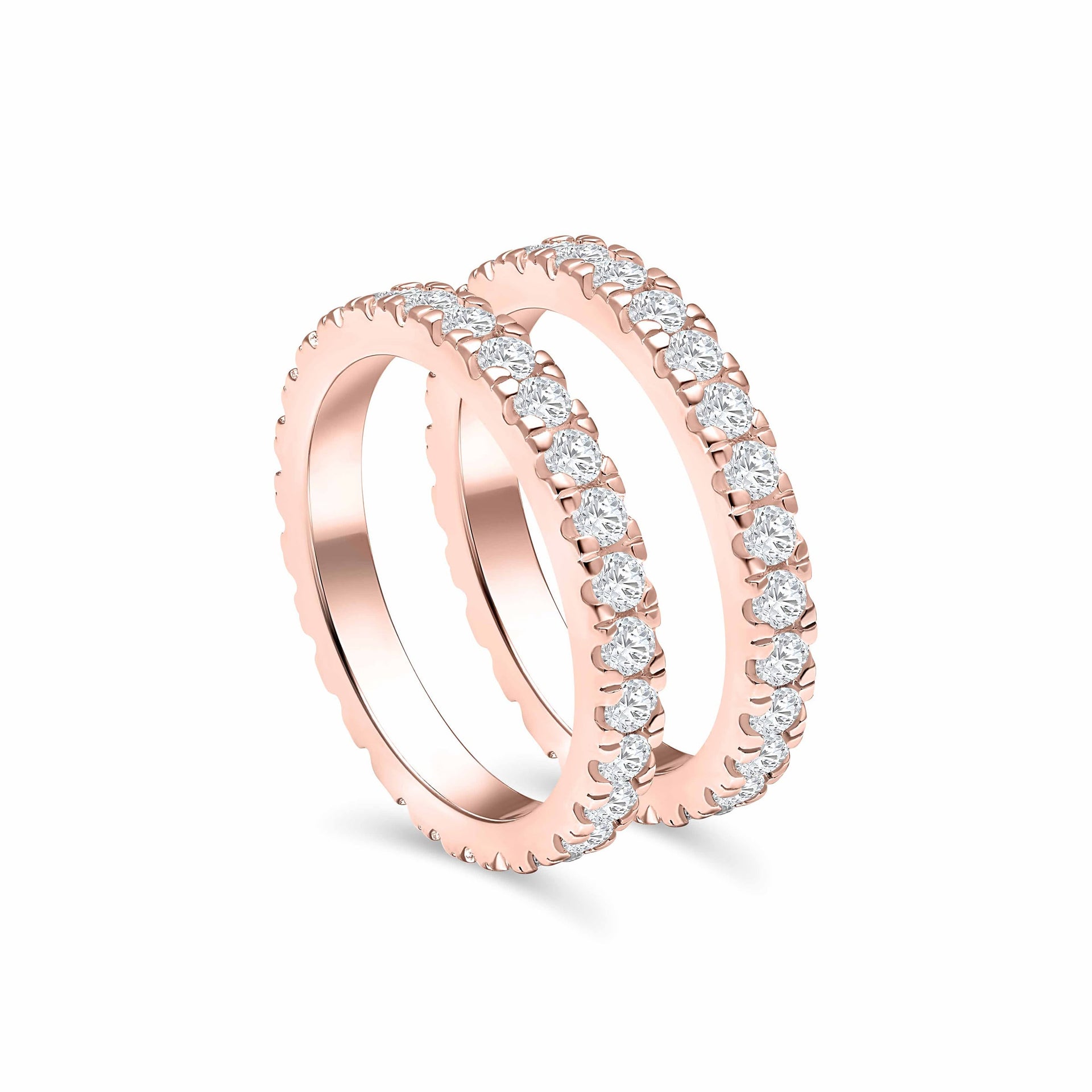 set of two rose gold eternity wedding bands at a tilted angle