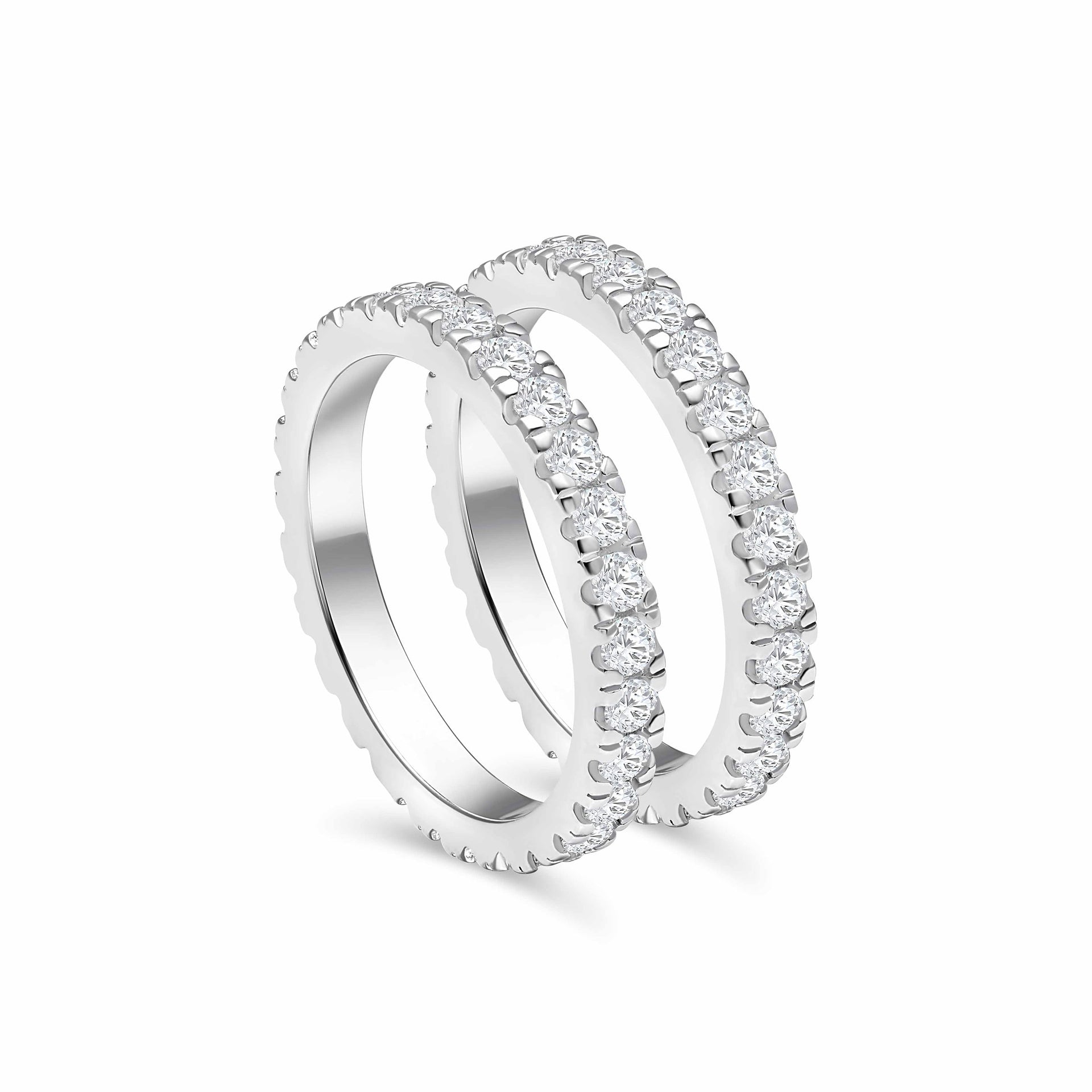 a set of silver full eternity wedding bands next to each other at a slightly tilted angle