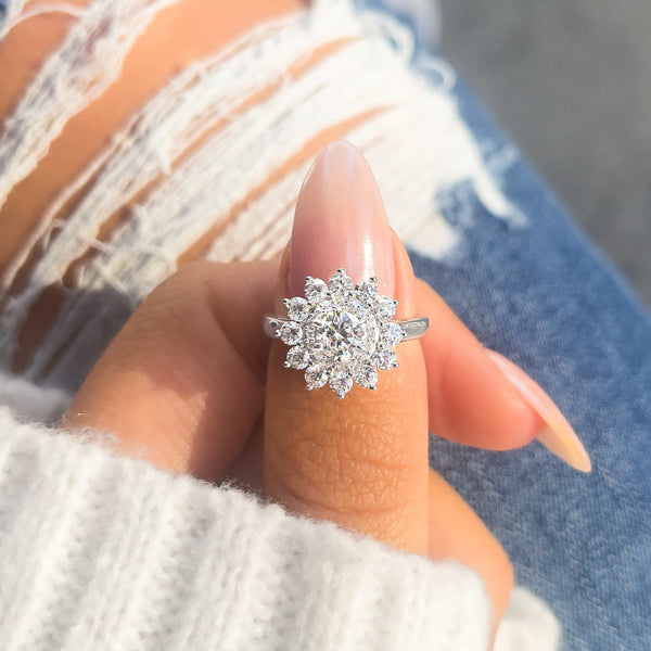 stunning Emily engagement ring on thumb in silver with jeans in background and white sweater