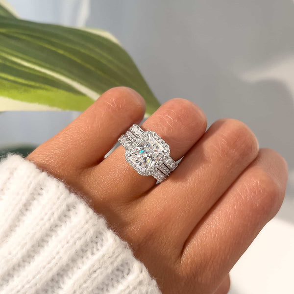 radiant cut engagement ring paired with two silver statement eternity bands on a female model in white sweater