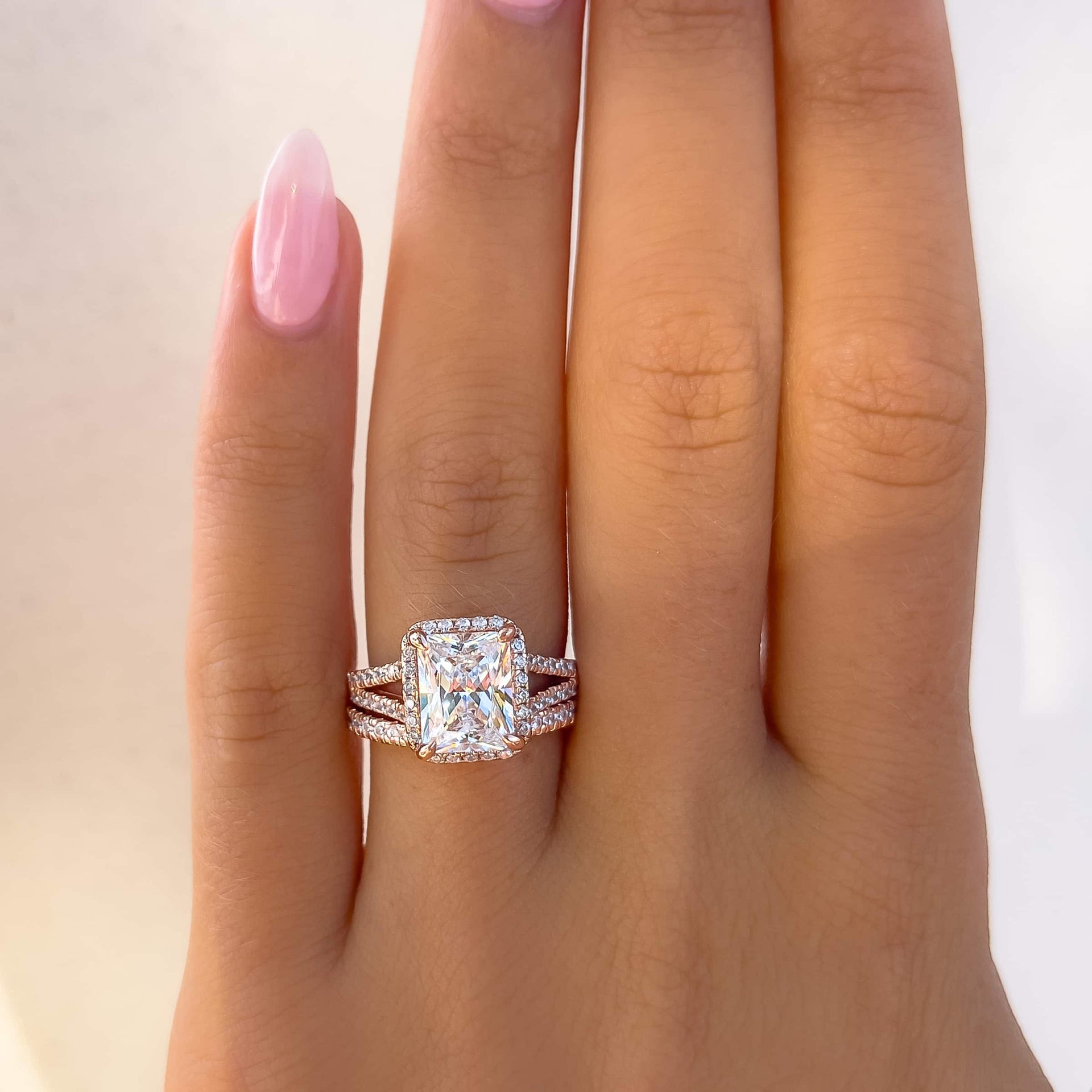 Radiant cut, with a shimmering halo surrounding the center stone with a unique, split half eternity band