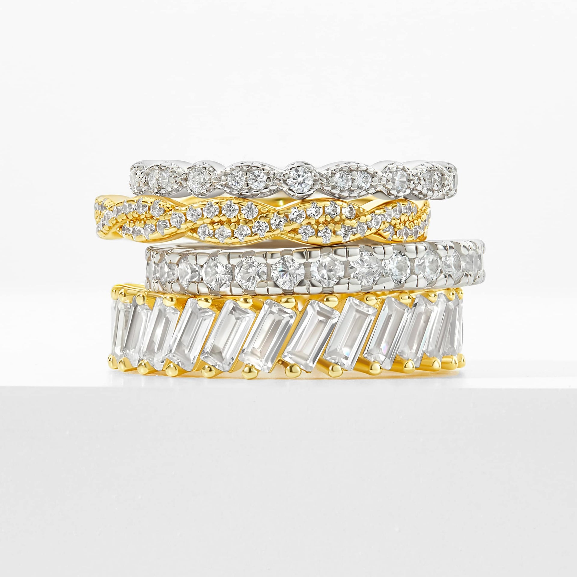 a stack of silver and gold wedding bands