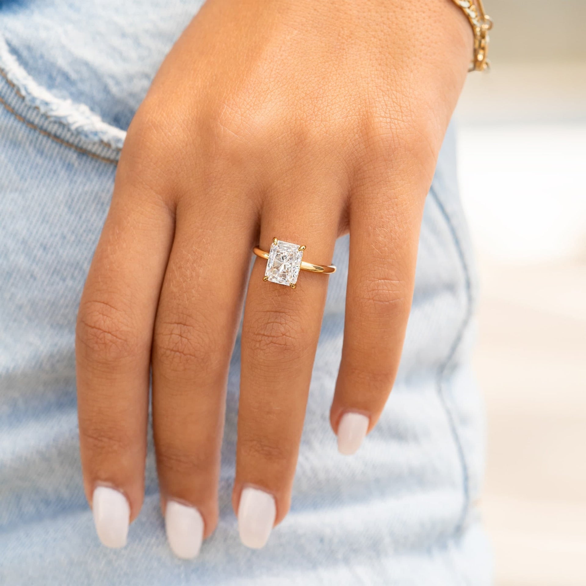 Radiant cut diamond alternative ring with hidden halo.