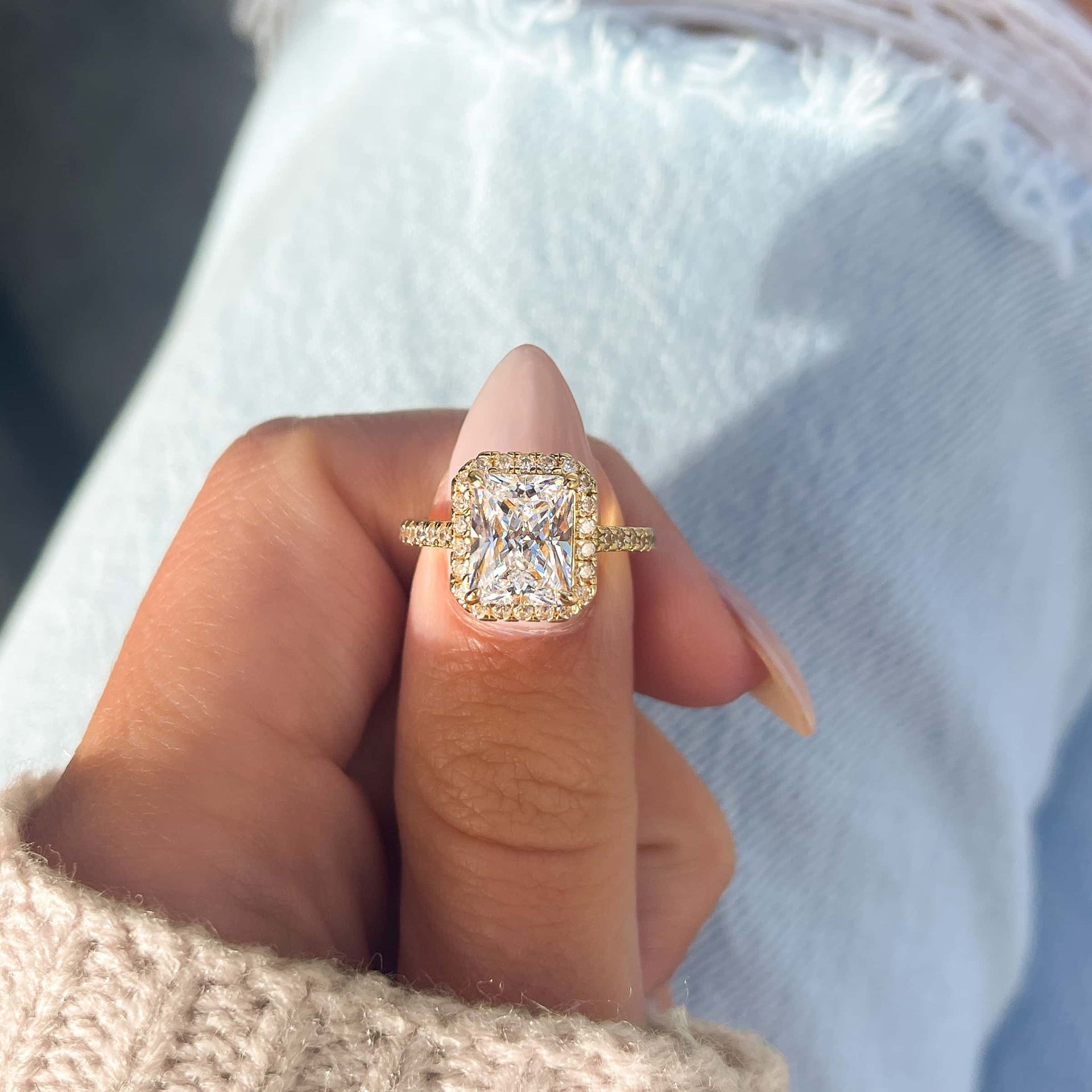 3.5 carat gold halo engagement ring modeled on female hand