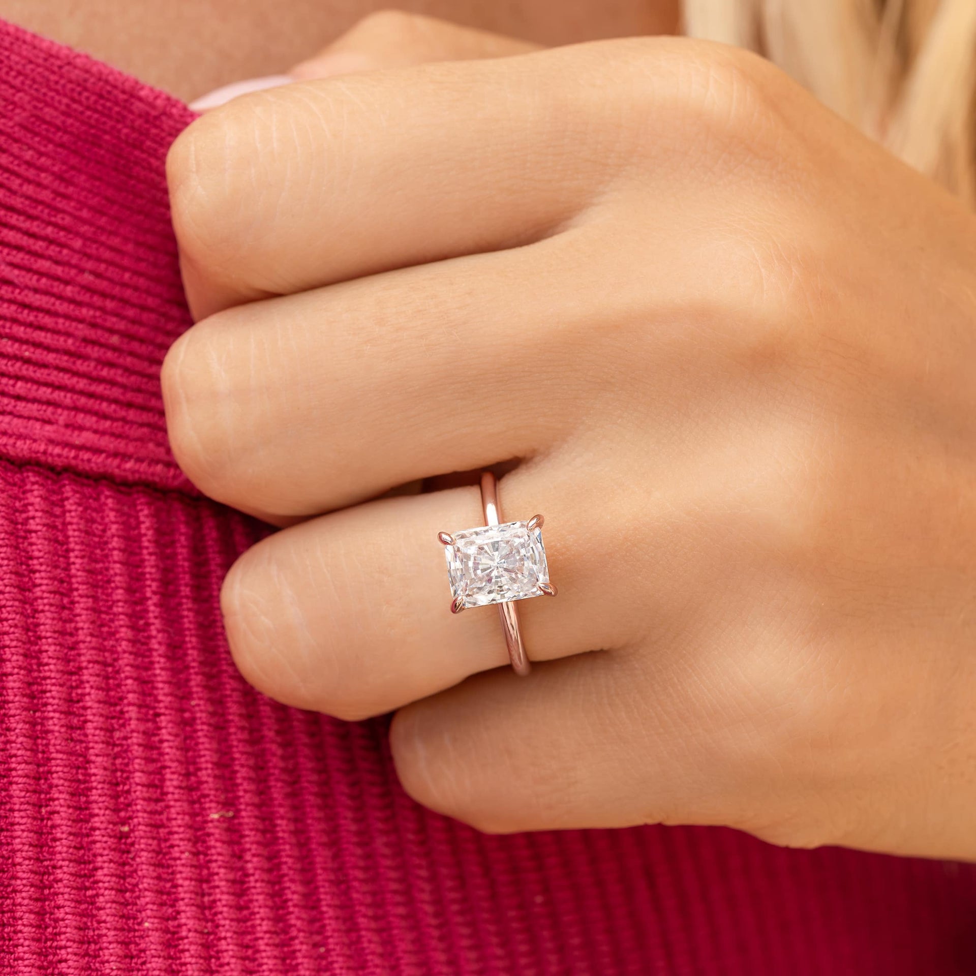 woman wearing rose gold radiant cut engagement ring