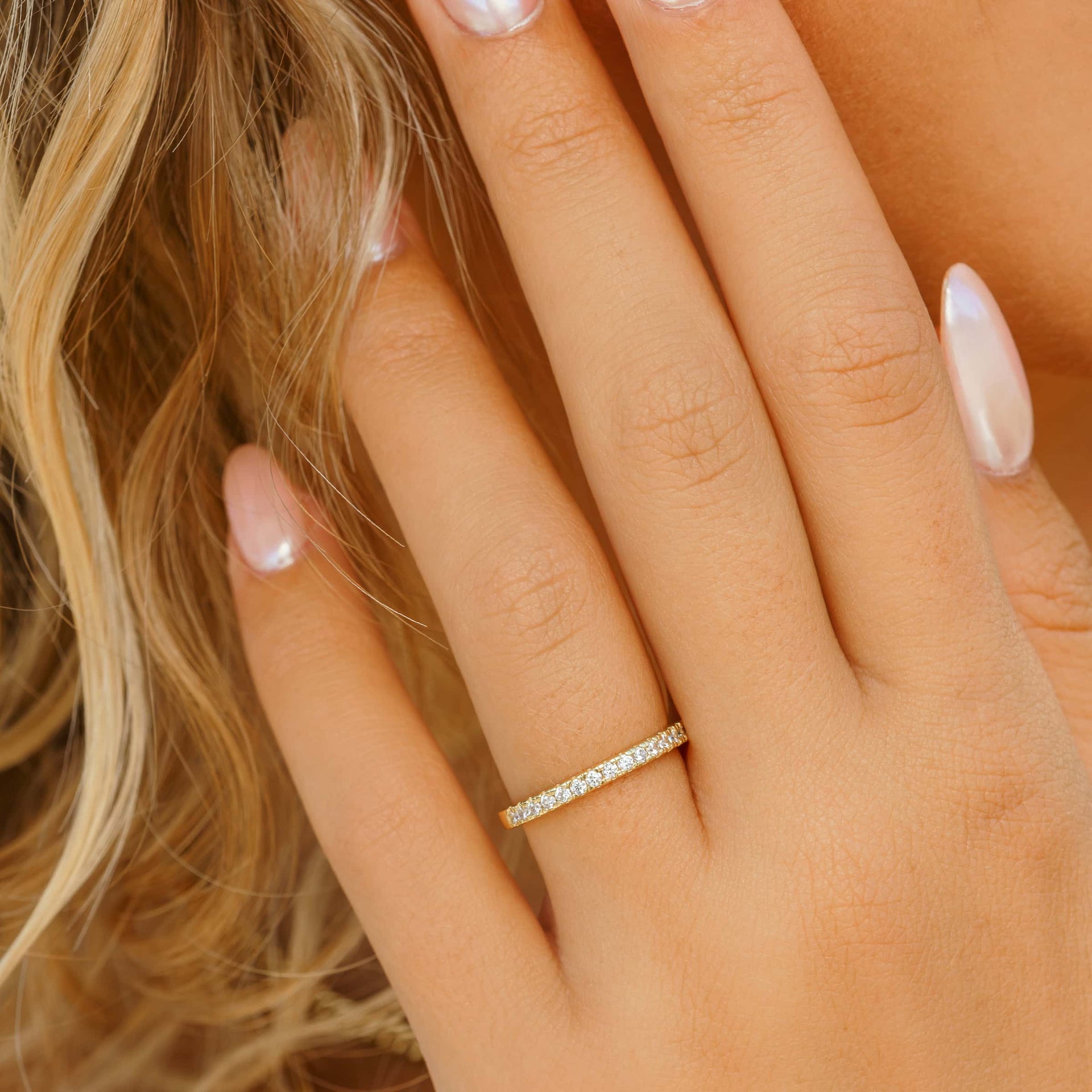 woman wearing gold simple wedding band