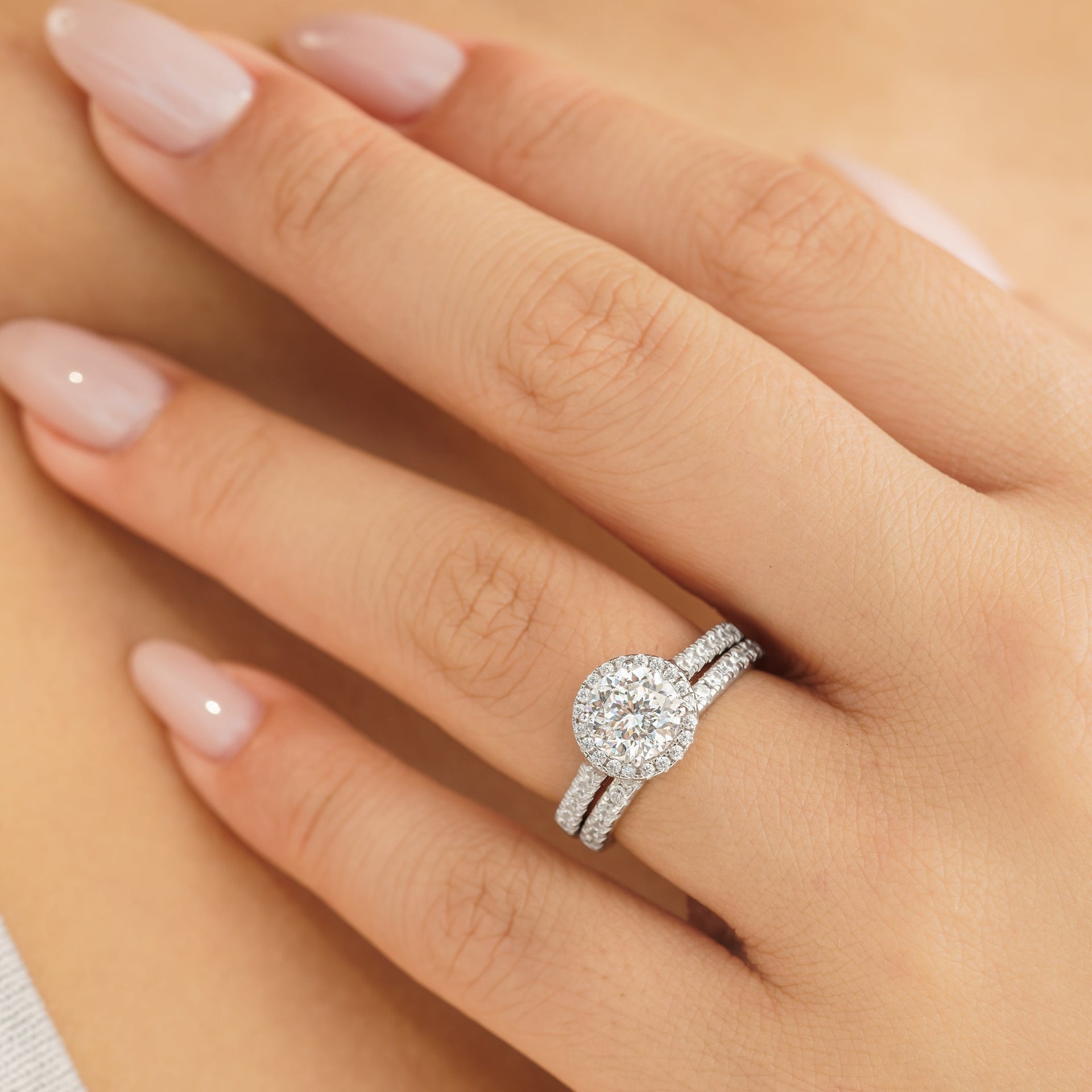 woman wearing round cut wedding ring set in silver