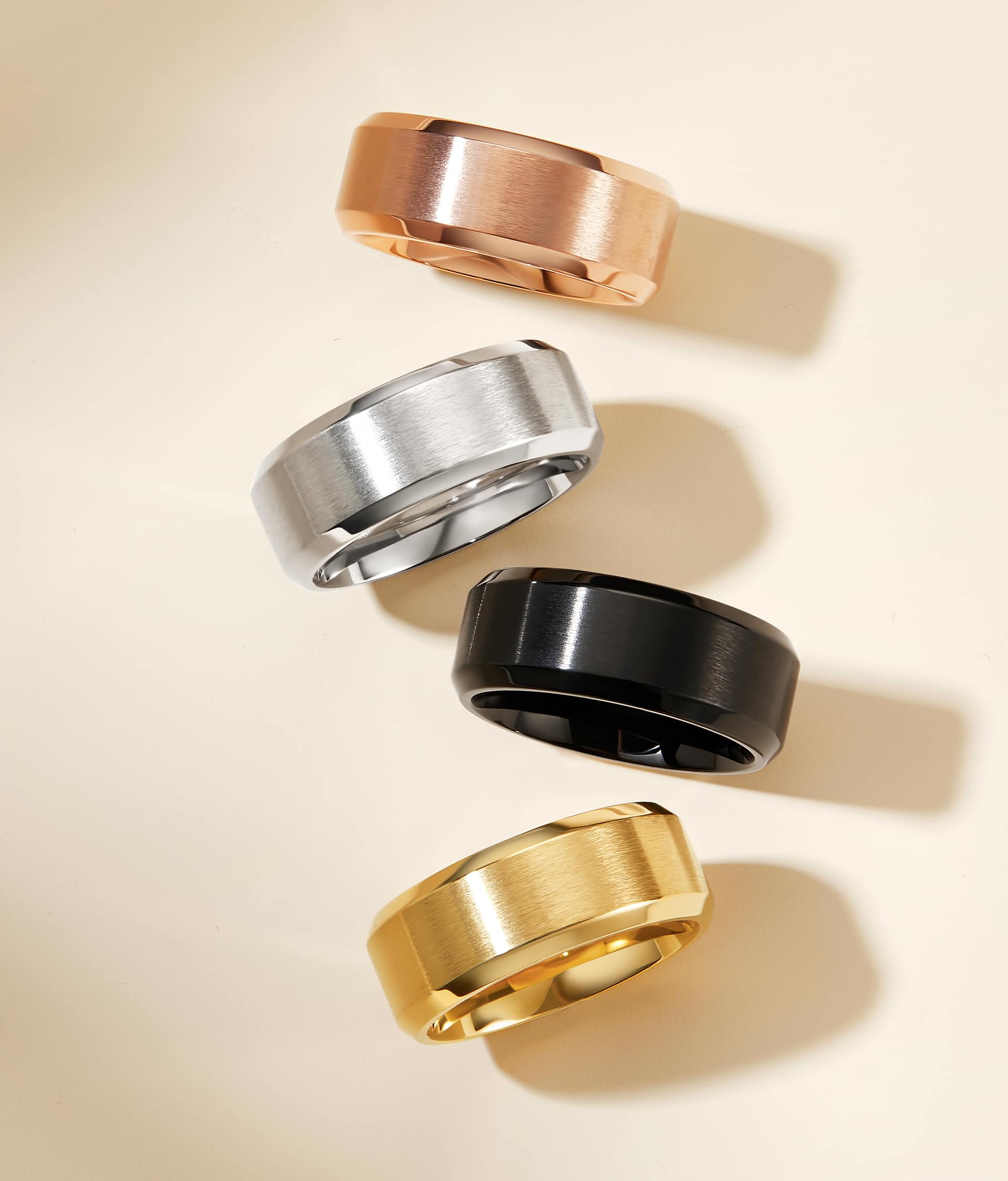 mens wedding bands in rose gold, silver, black, and gold