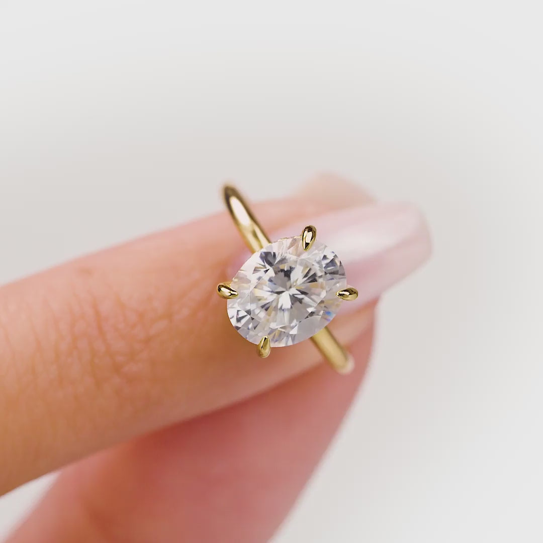 wiggle of gold solitaire oval engagement ring with hidden halo