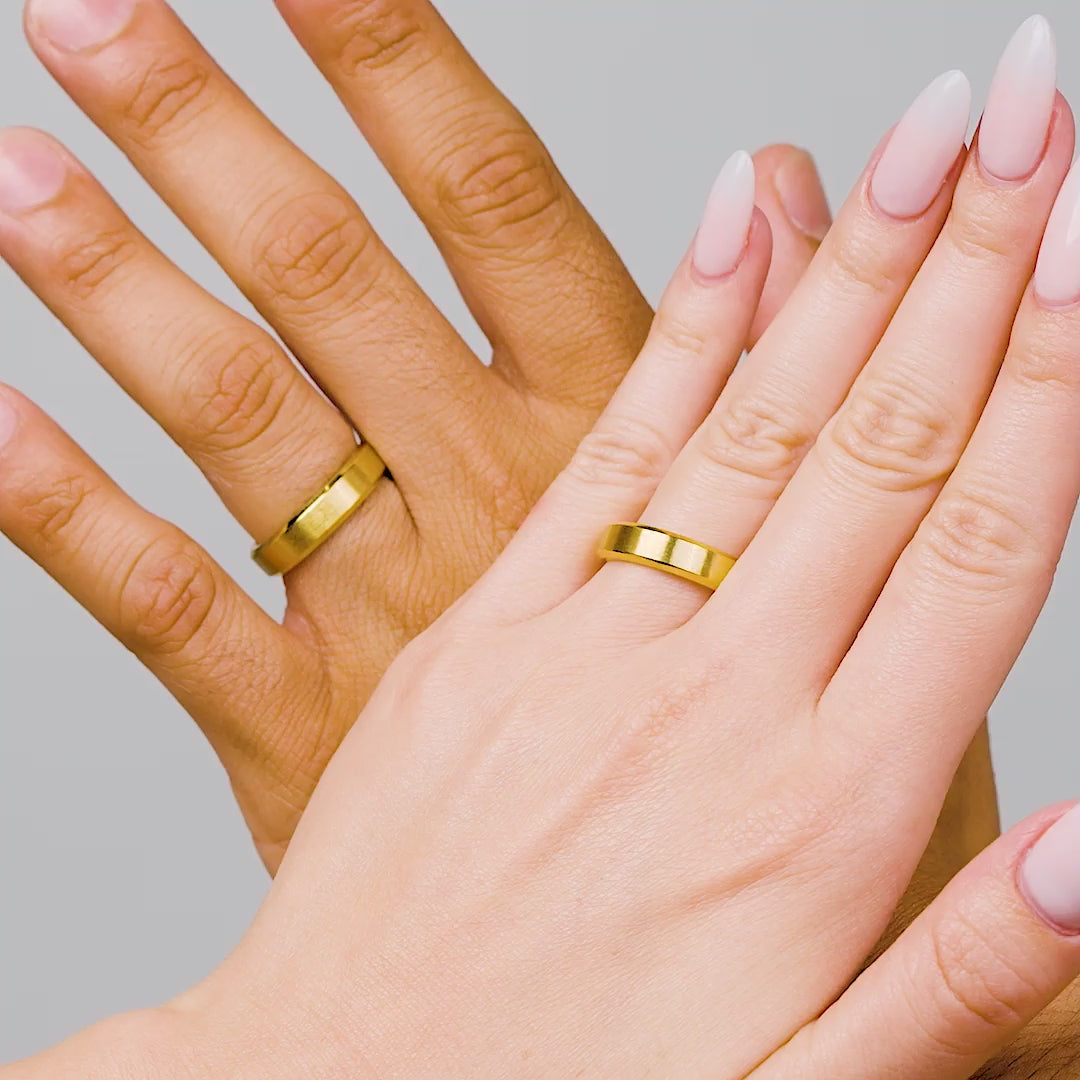 Male model and female model wearing gold titanium wedding band in video format