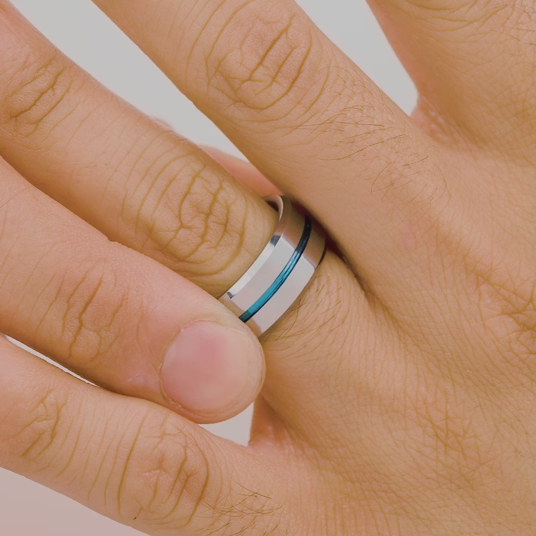 silver mens ring with blue stripe going down middle