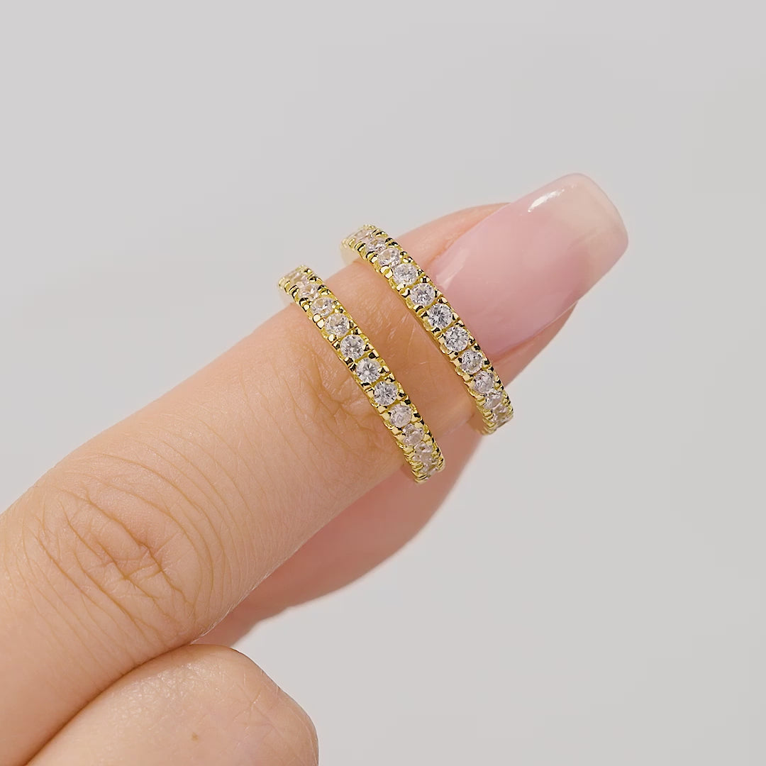 short video showcasing our 2.6mm gold eternity wedding band set stacked with a gold oval cut engagement ring on a female hand