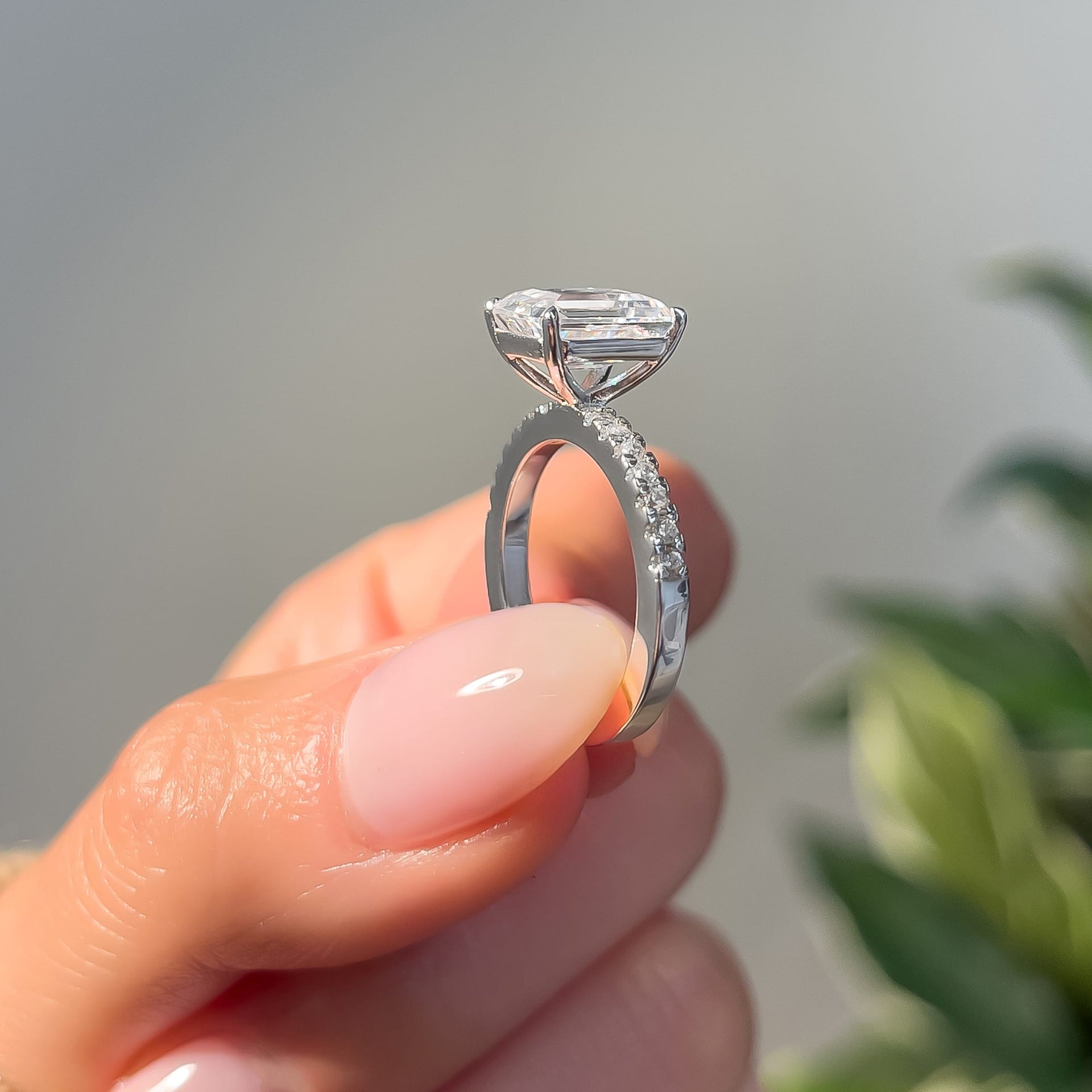 side profile of silver engagement ring with half eternity band detailing
