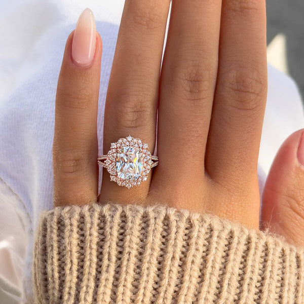 stunning cushion cut engagement ring with white jeans and a brown sweater