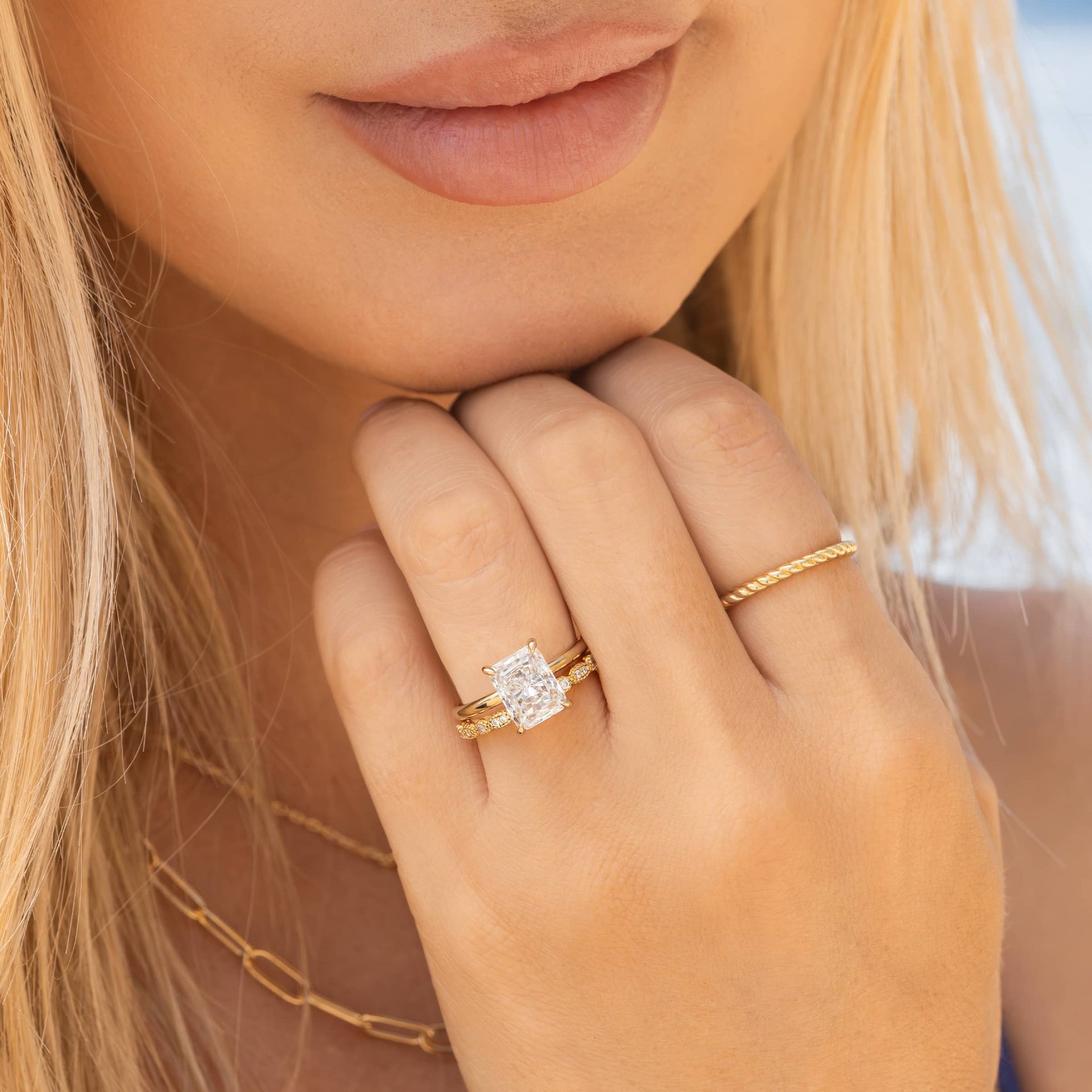 woman wearing gold radiant cut engagement ring