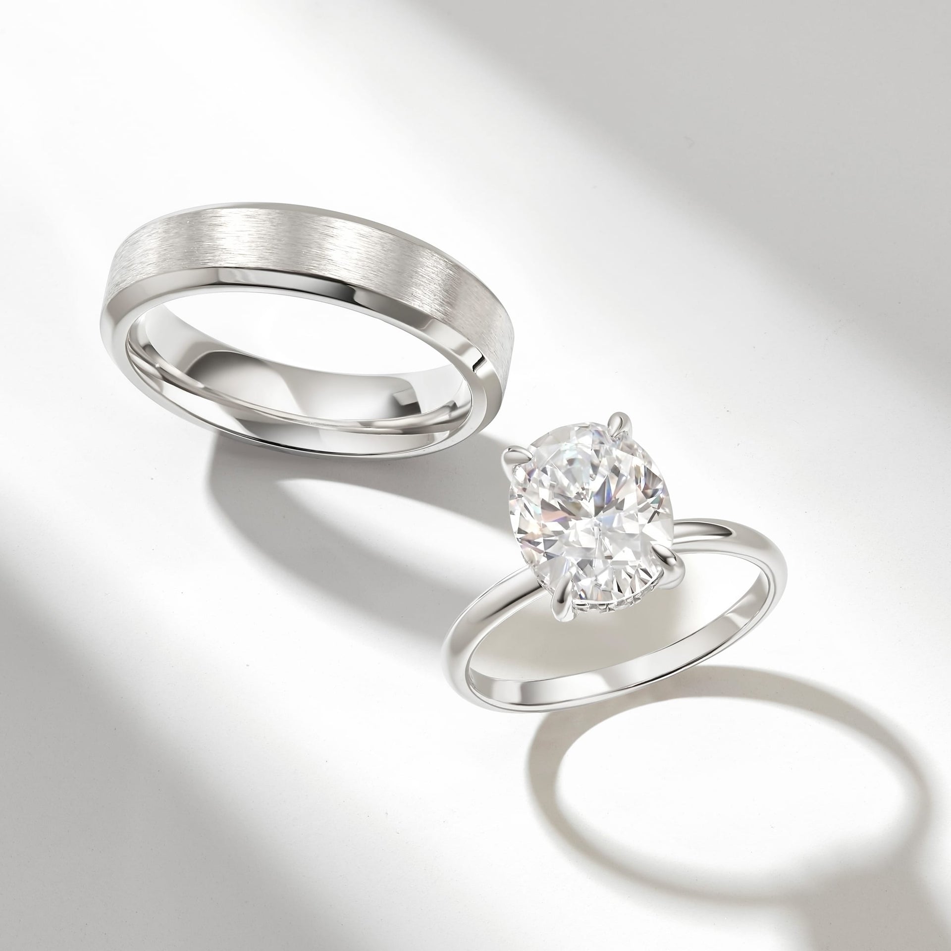 the elena shown in silver with complimentary mens wedding band on neutral gray background