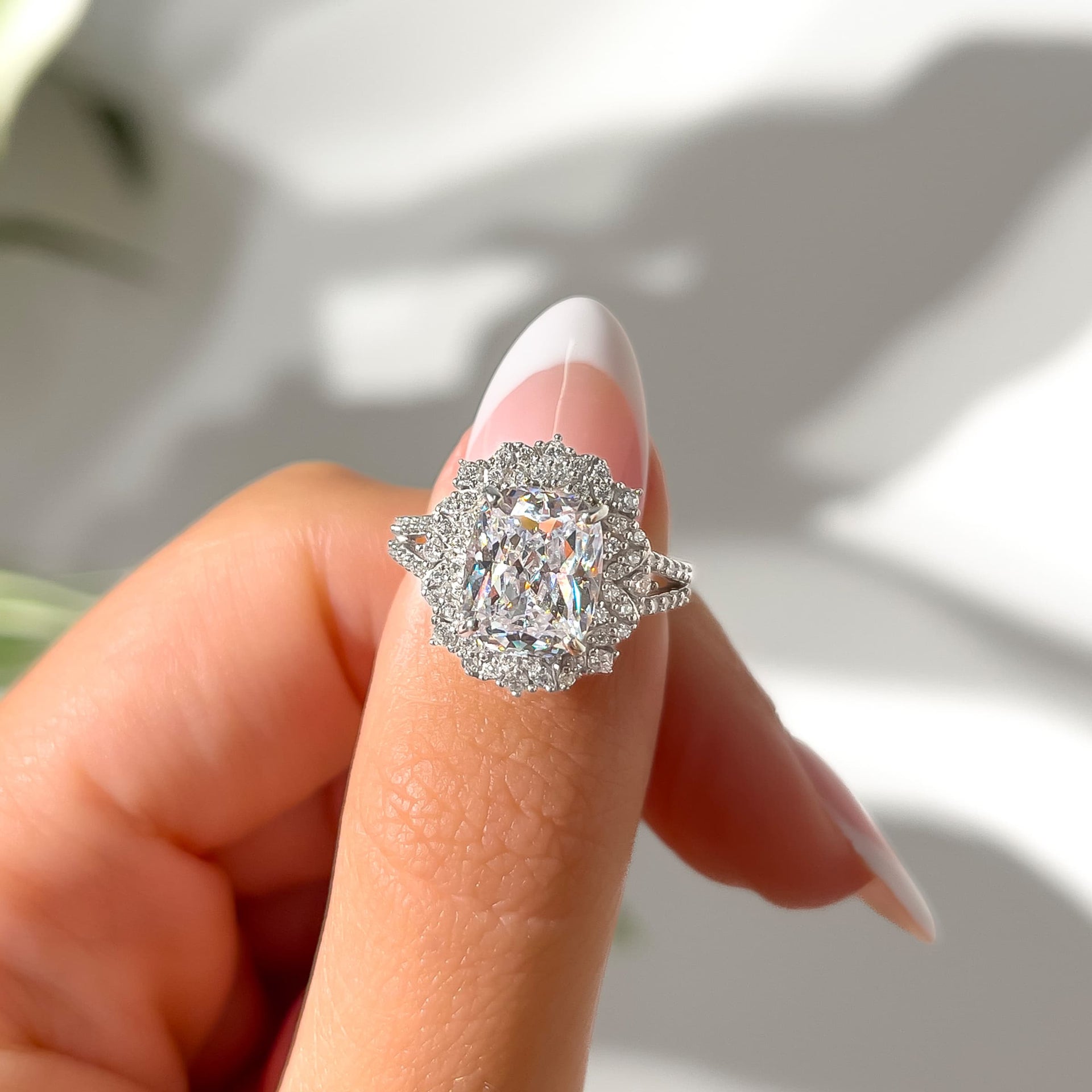 stunning vintage elongated cushion cut engagement ring on model with french tip nails