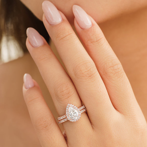 the bliss rose gold wedding ring set on female hand