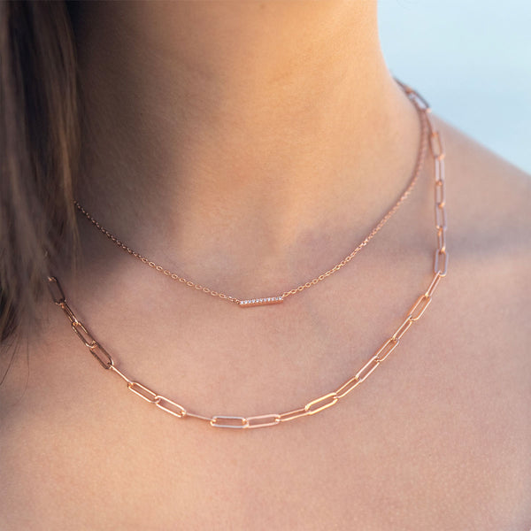 Rose gold layered necklaces on model