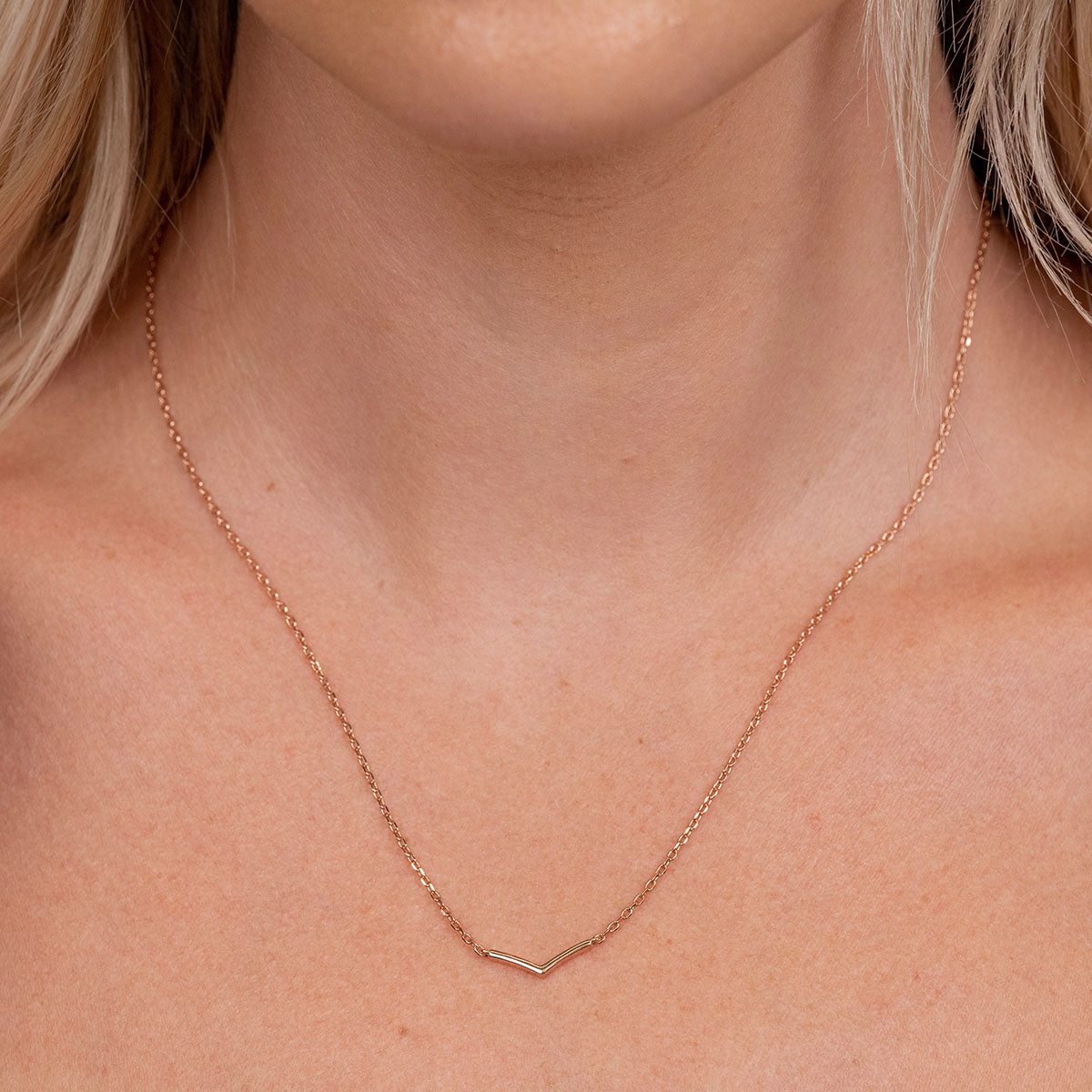Rose gold v shaped necklace on model
