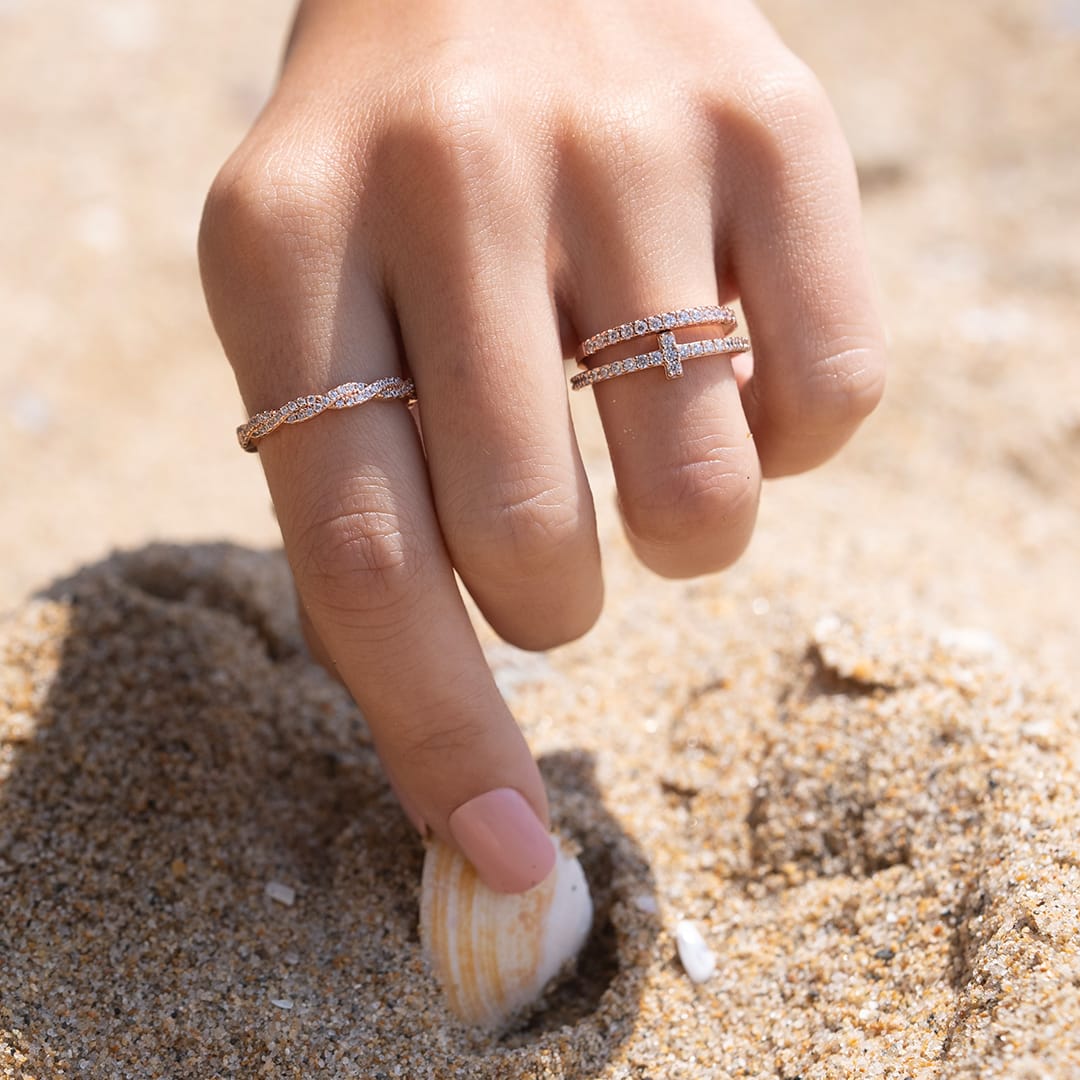 hand grabbing shell wearing wedding bands
