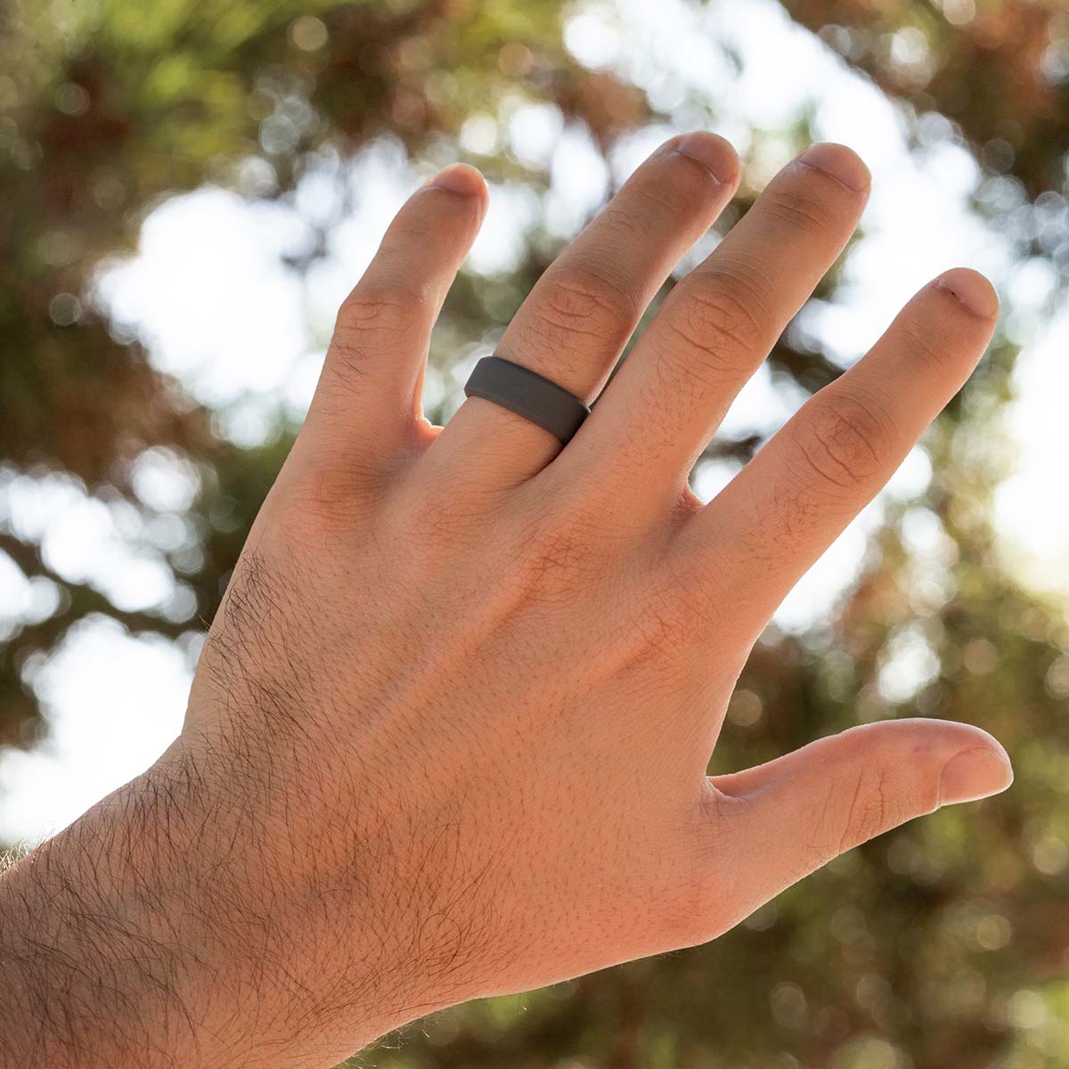 Male Hand wearing a gray rubber wedding ring
