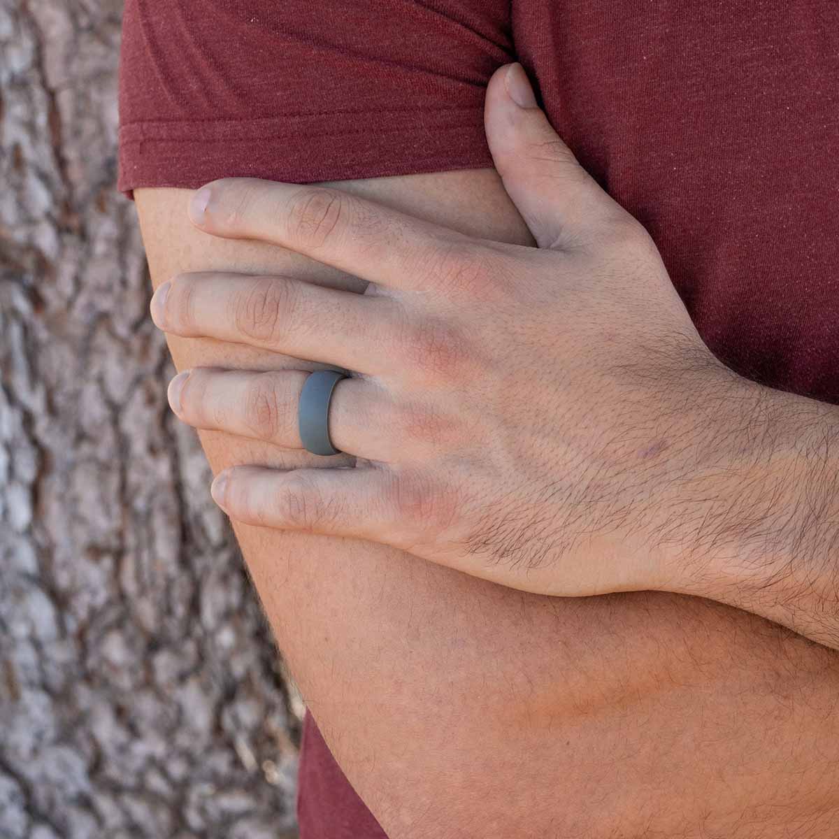Male Hand wearing a gray rubber wedding ring