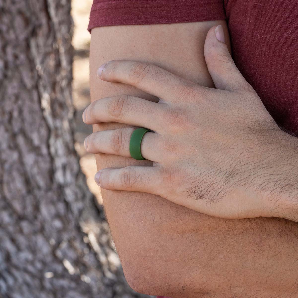 Male hand wearing a comfortable green silicone ring