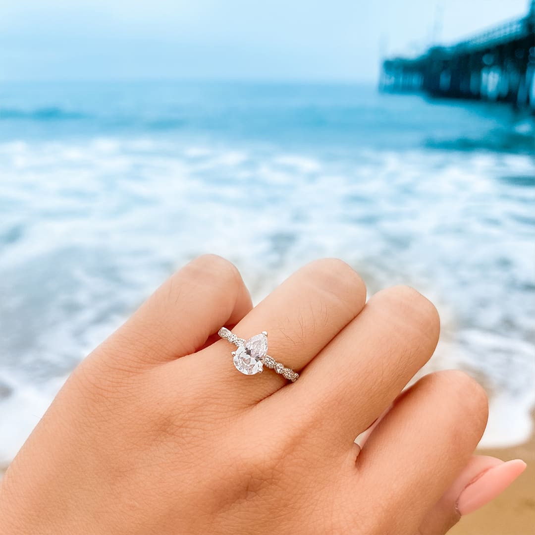 Pear shaped engagement ring at beach