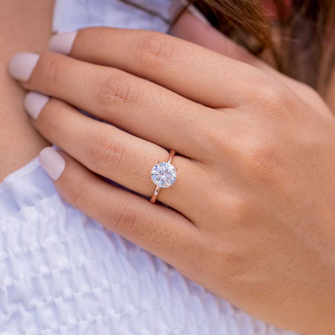 lady wearing the one and only rose gold round cut solitaire engagement ring