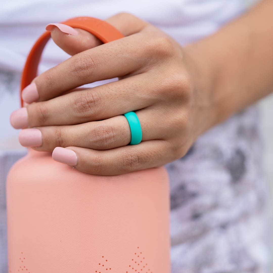 girl holding bottle with teal silicone flex wedding ring