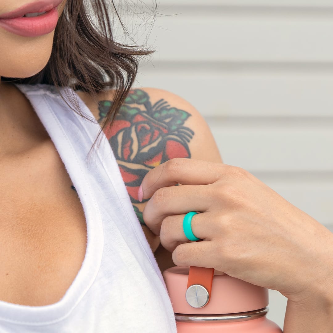 girl holding water bottle with teal flex wedding ring